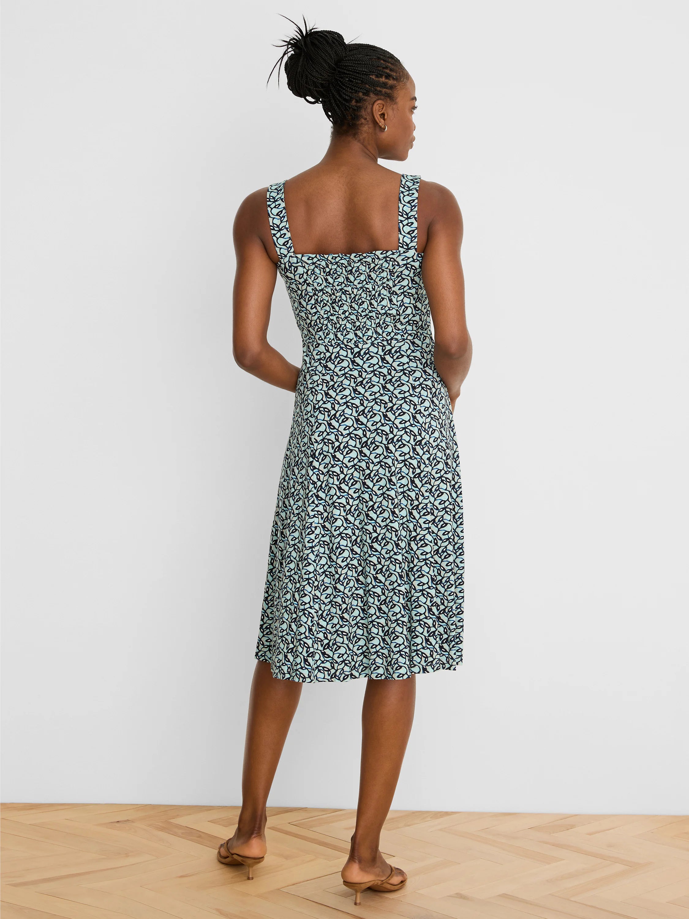 Light teal midi dress with dark blue & light blue abstract vine pattern. Features wide straps & shirred back.