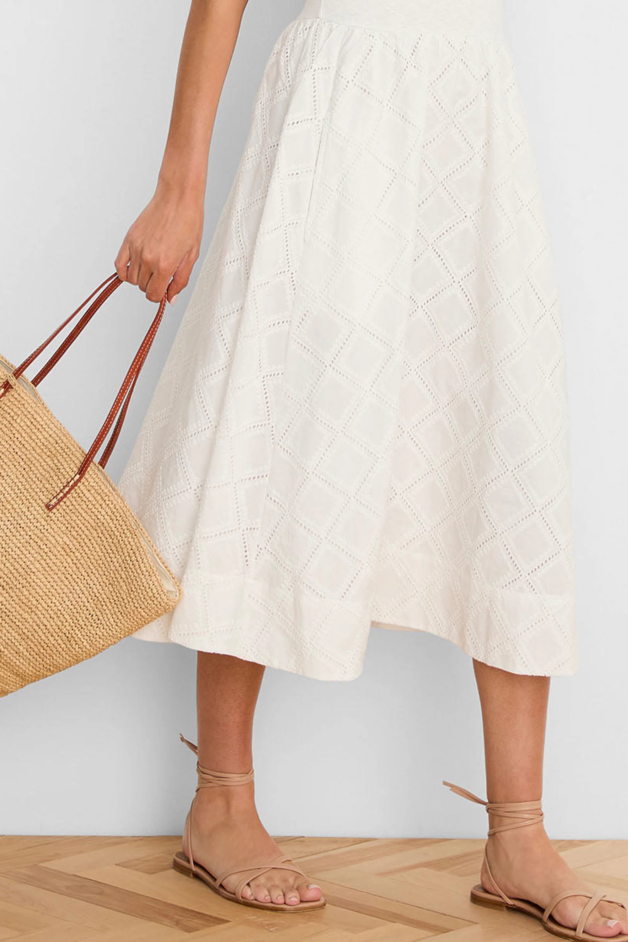 Off-white flowing midi dress with a textured diamond eyelet pattern.