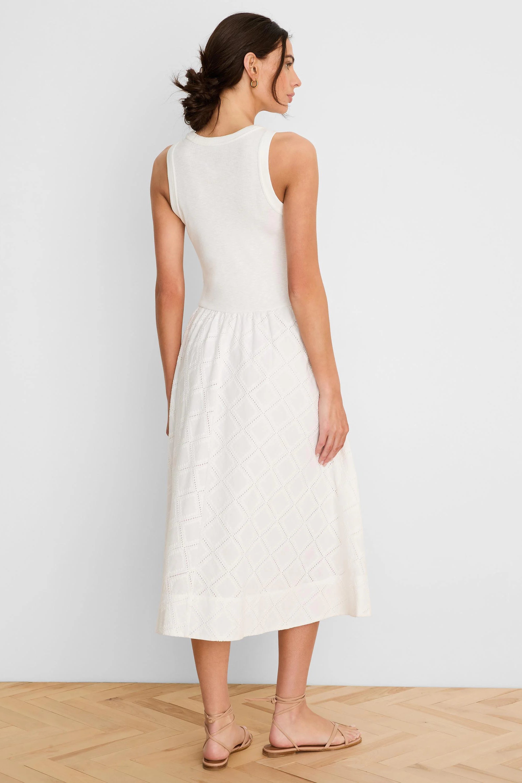 Off-white sleeveless midi dress with ribbed knit top and flared skirt featuring a diamond eyelet pattern.