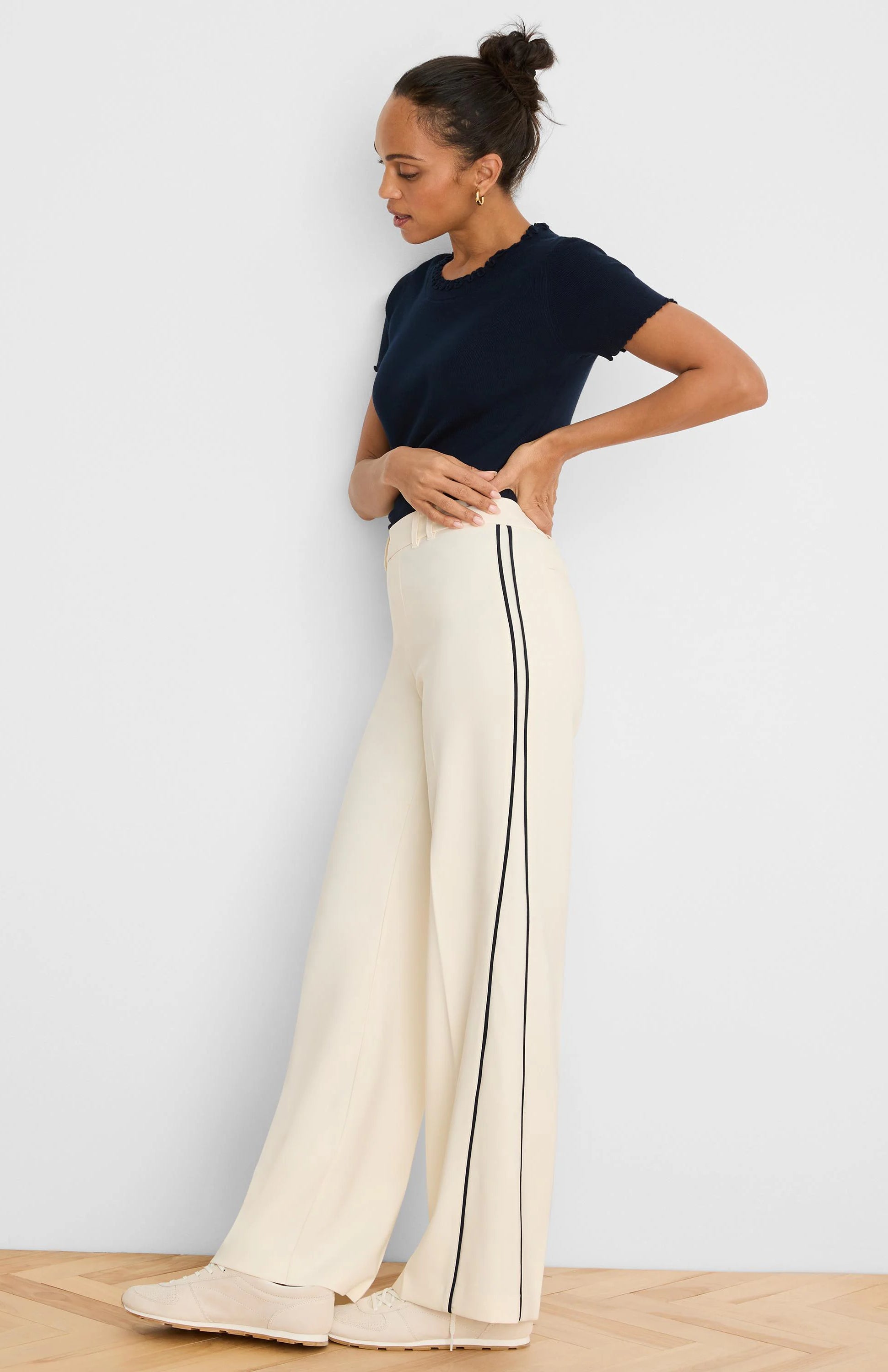 Ecru wide leg pants with black double piping down the outer seams.