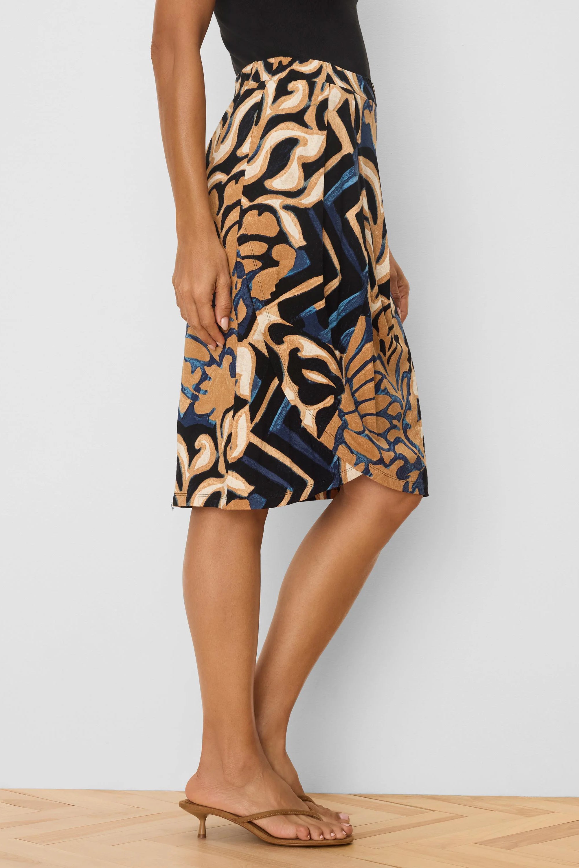 Tan, black, blue, and cream abstract pattern knit midi skirt.