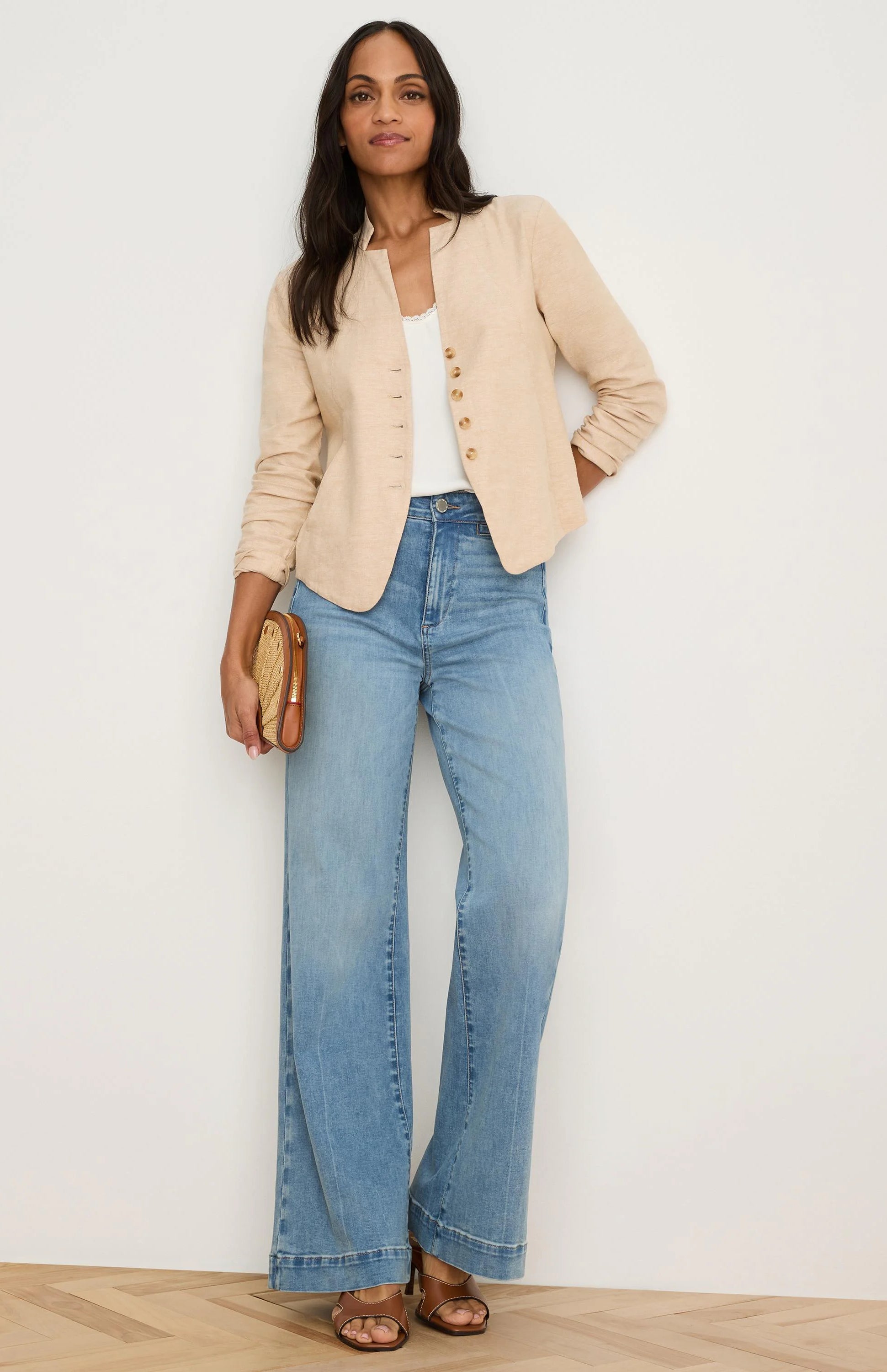 Light beige linen jacket, collarless with split neckline & single row of small brown buttons. Sleeves are rolled.