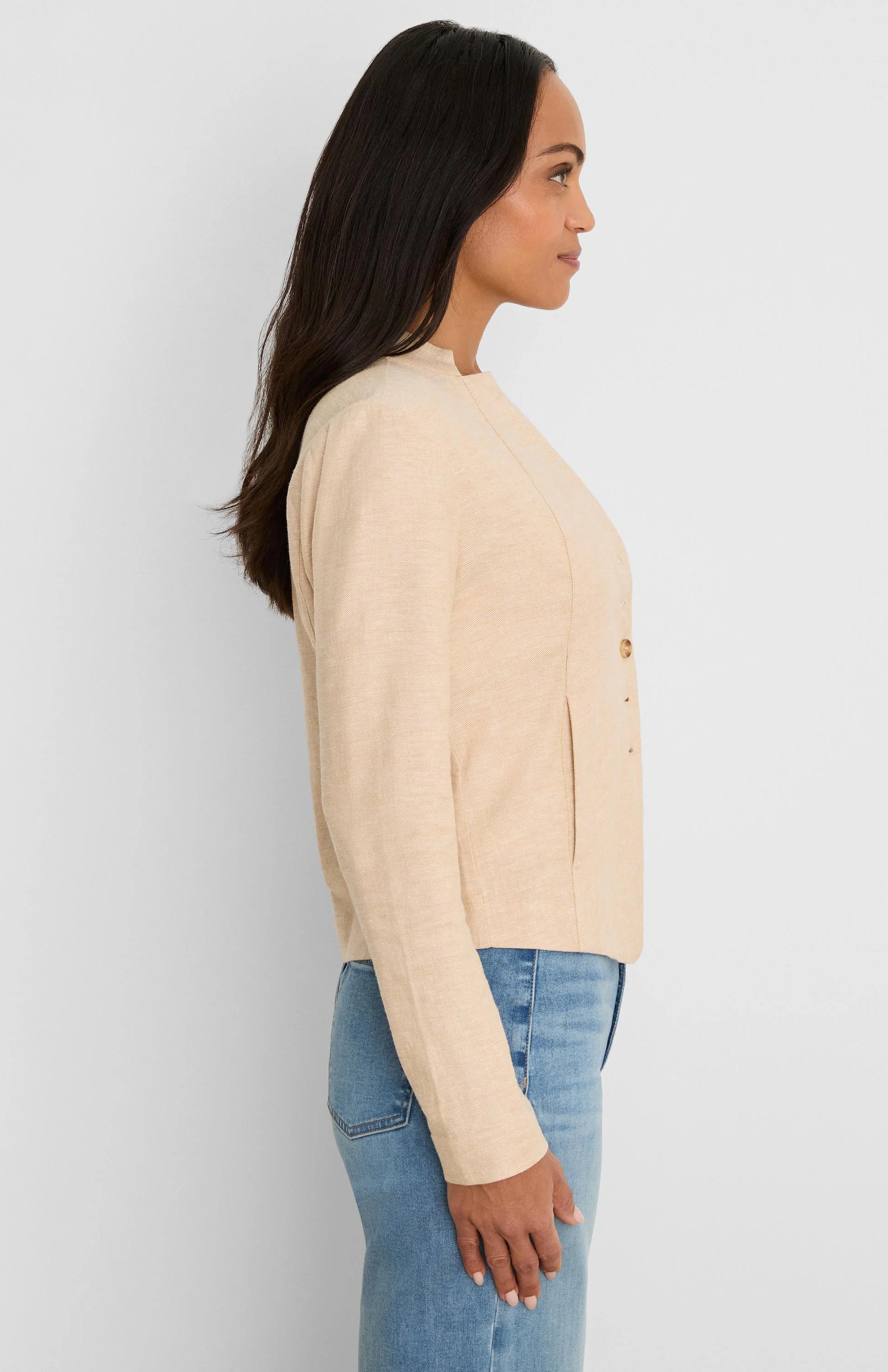 Light beige stretch linen jacket, collarless with rounded neck, long sleeves, front seam, and two small buttons.