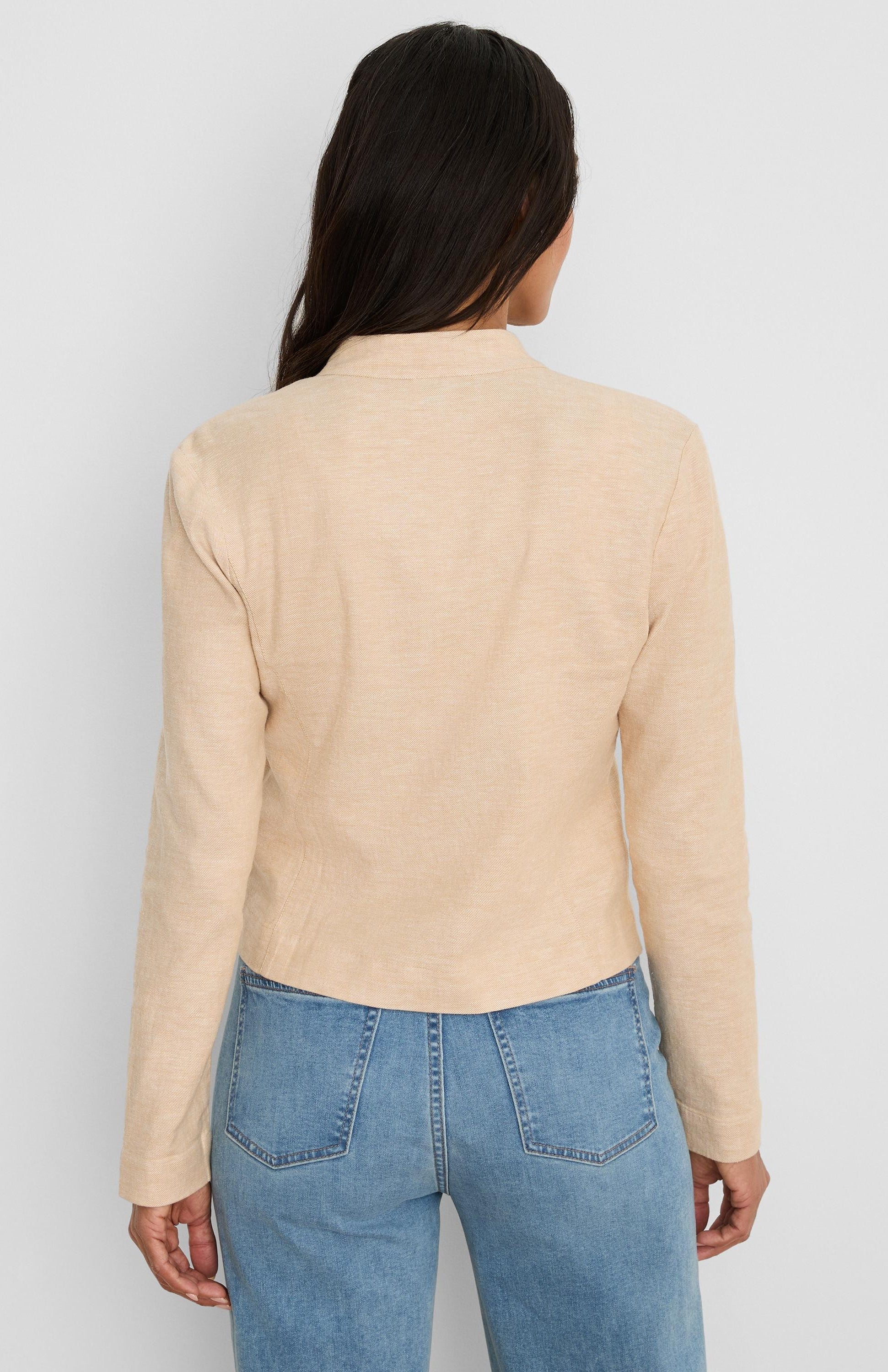 Light beige stretch linen jacket, long sleeves, stand collar, cropped to waist. Back view.