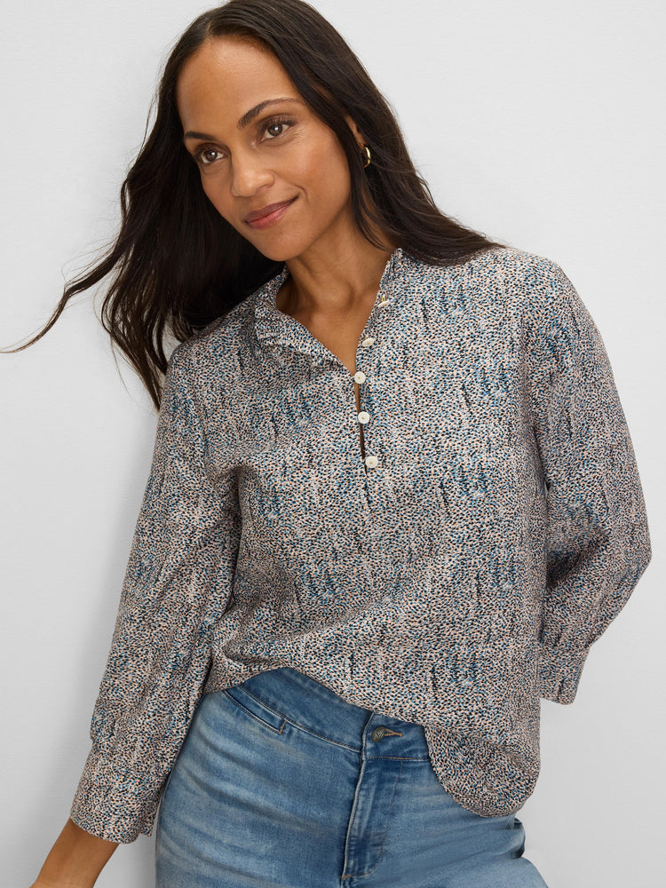 Light top with blue, black & tan speckles, ruffle neck & 3 pearl buttons.