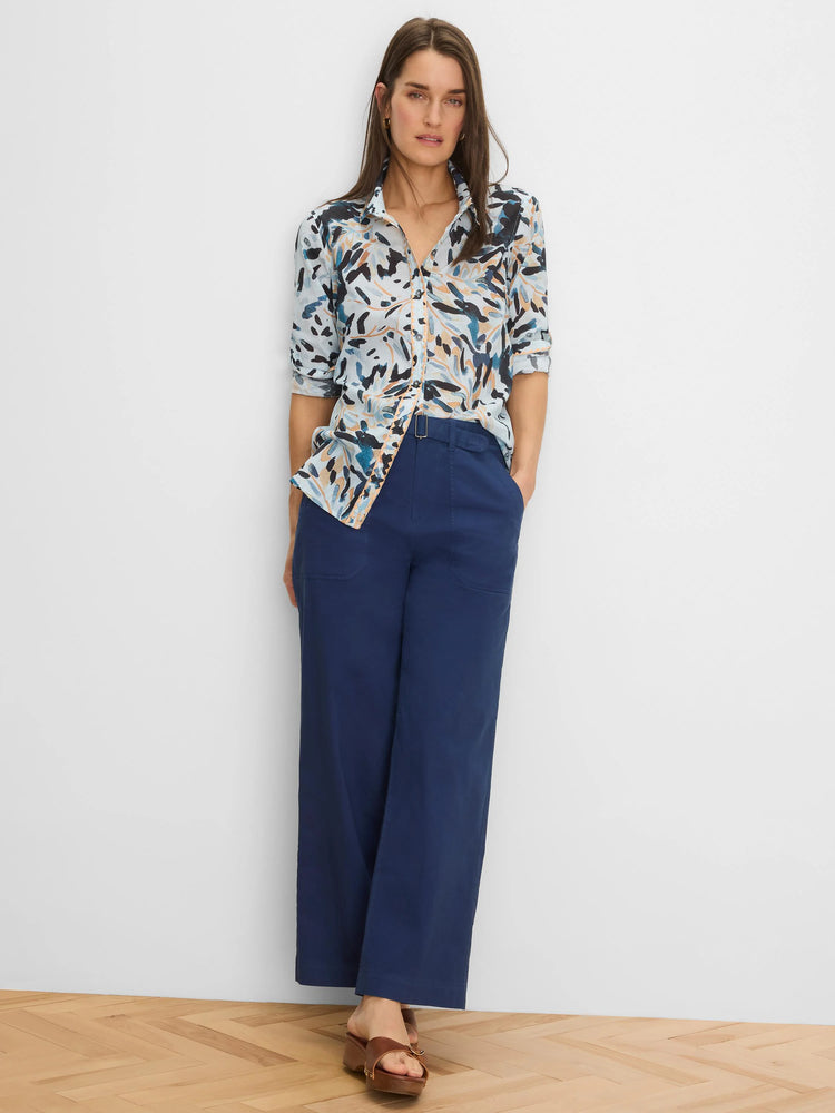Crinkle shirt: light background with abstract dark blue, tan, black brushstroke pattern. Button-up, rolled sleeves.