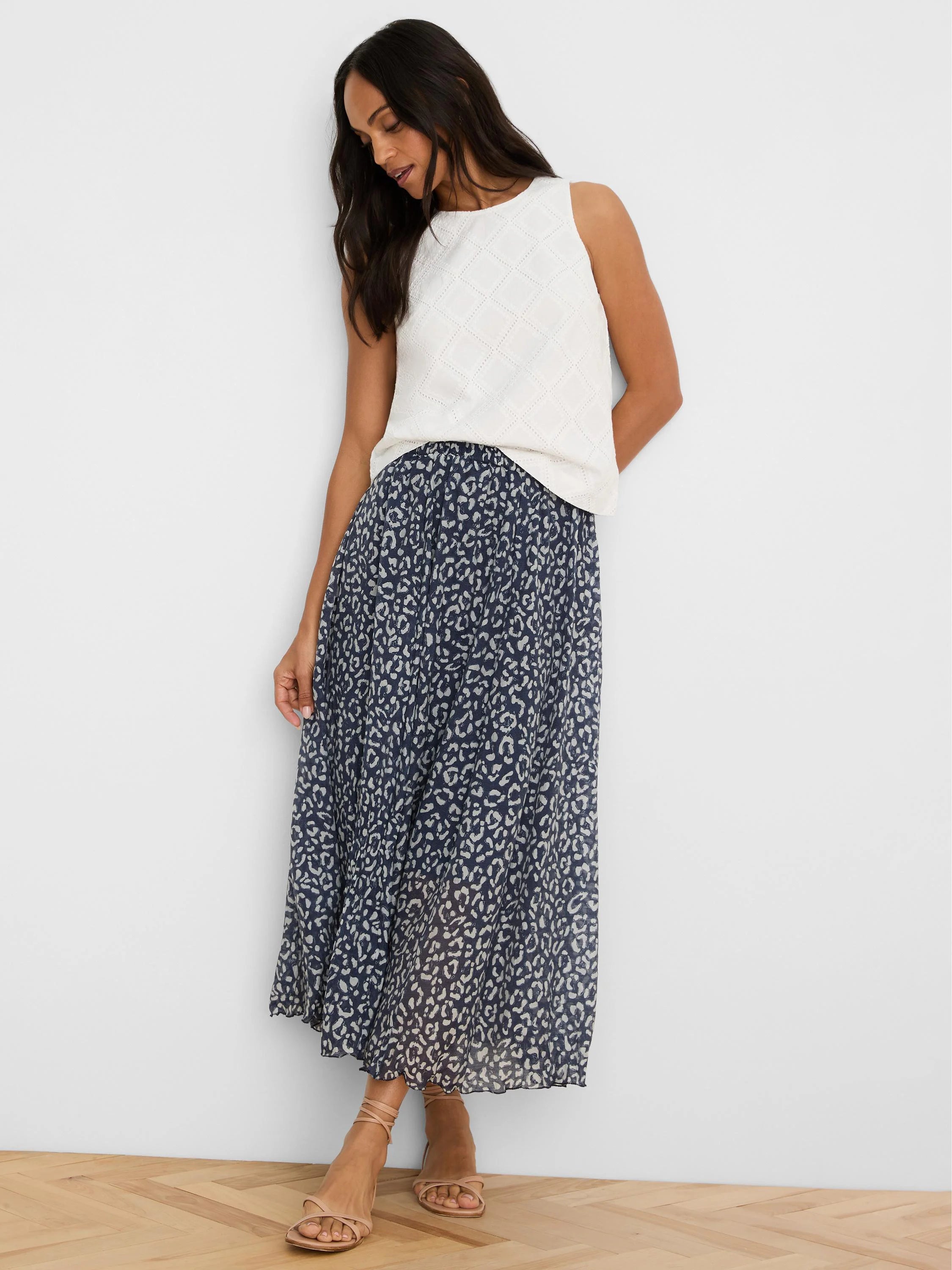 White sleeveless top with an all-over diamond eyelet pattern.