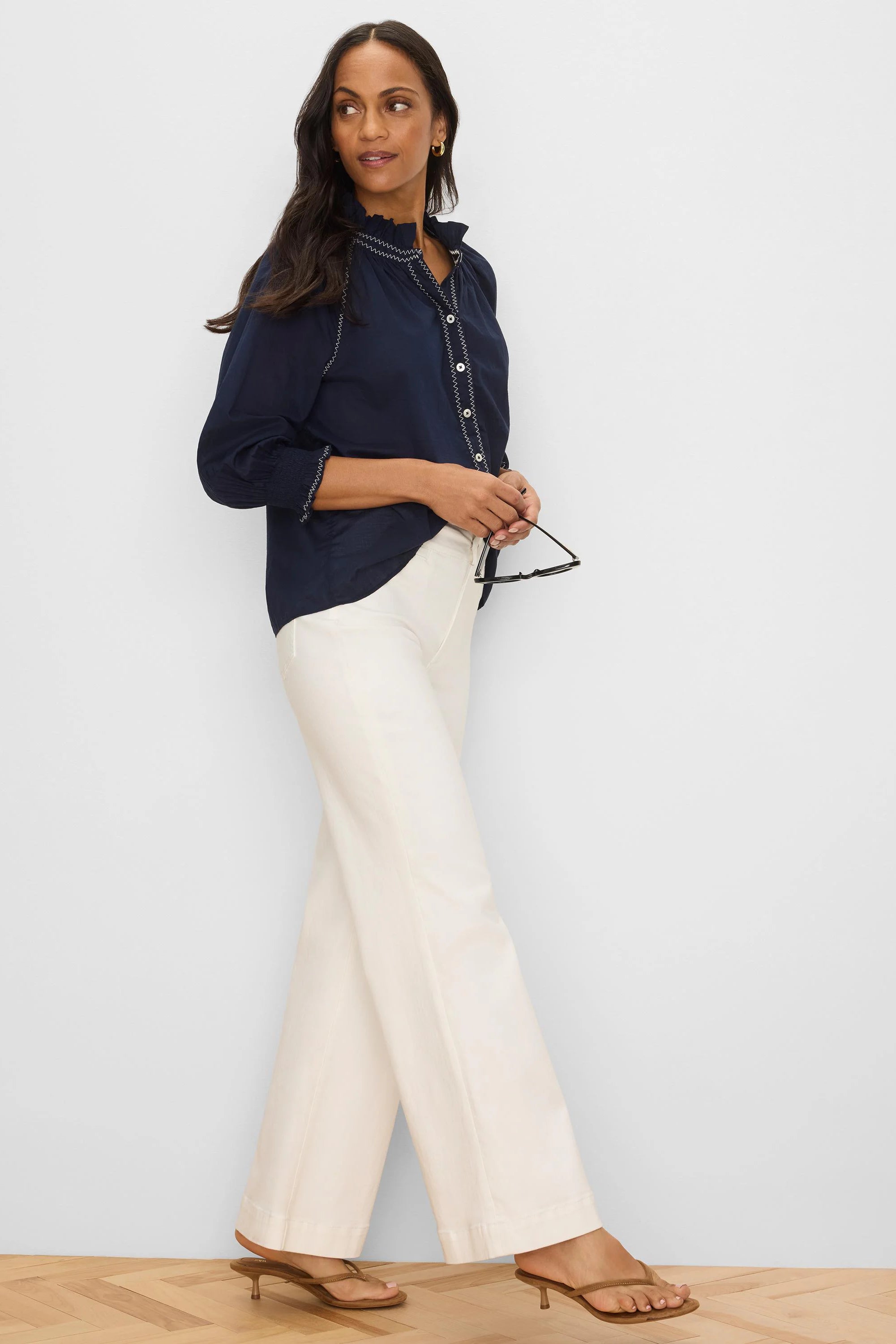 Navy crinkle shirt with white zig-zag stitching on collar, placket, and smocked cuffs.