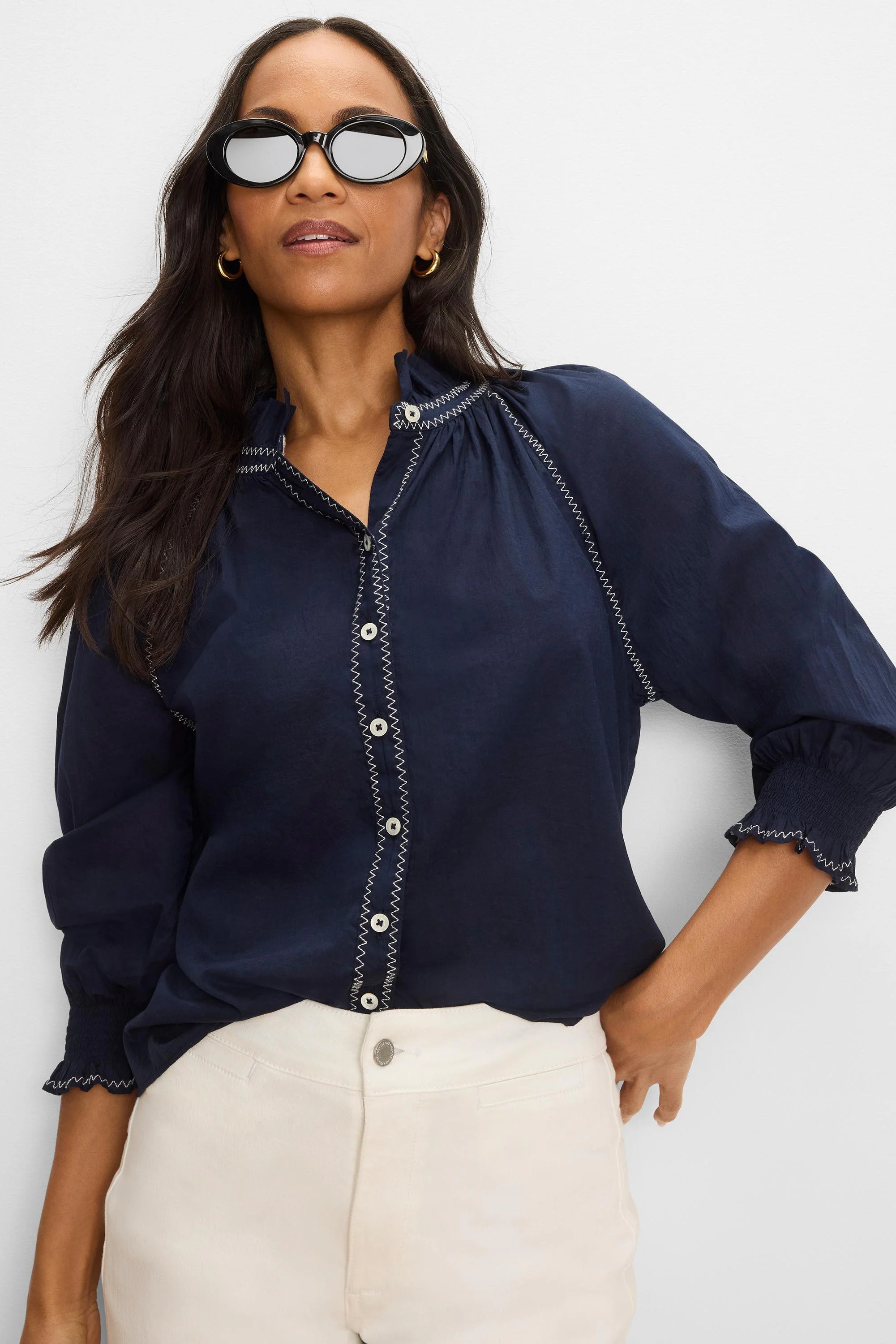 Navy blue crinkle shirt with white zig-zag stitching on placket, ruffled collar, and sleeves. White buttons & smocked cuffs.