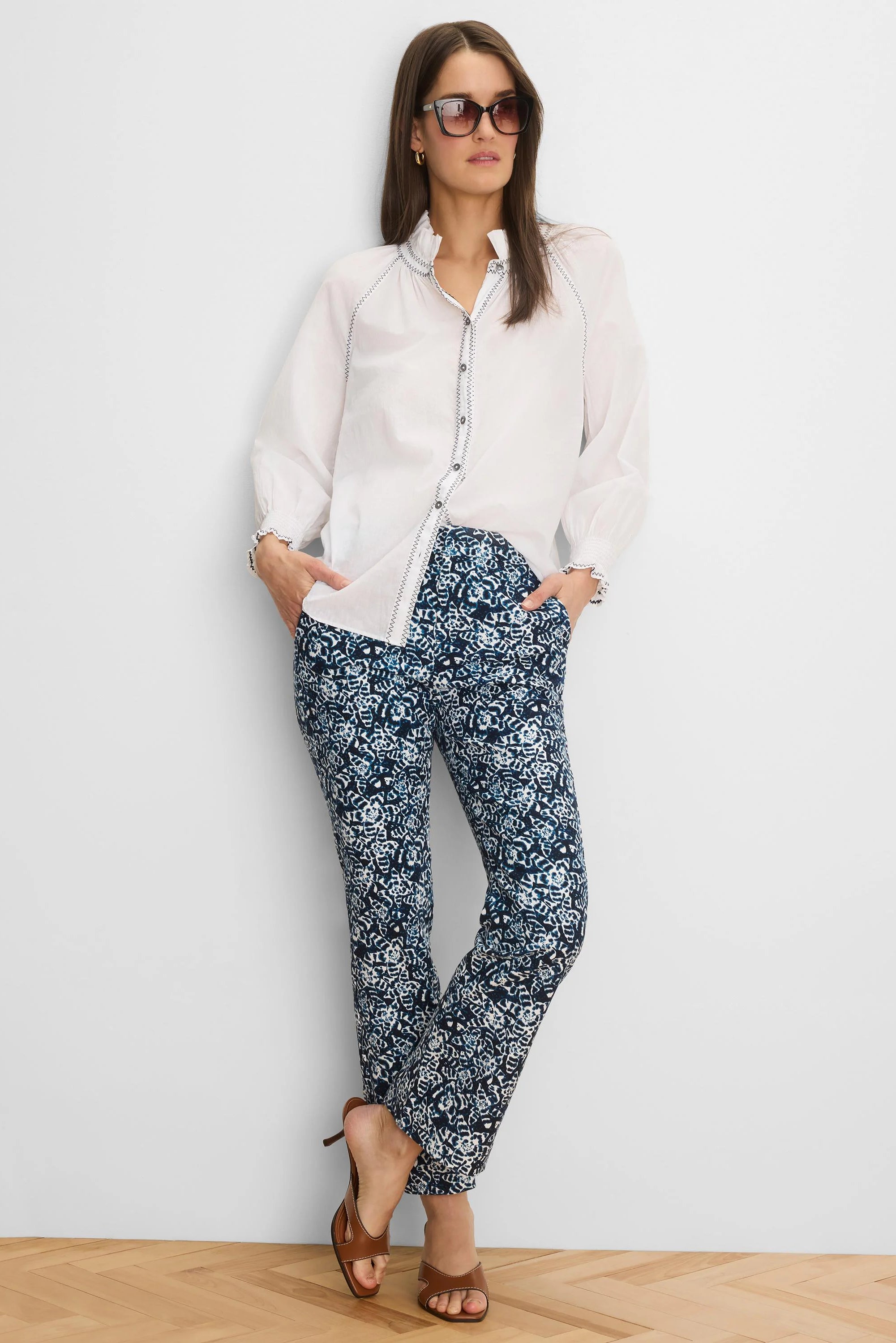 White crinkle shirt featuring dark zig-zag stitching on the ruffled collar, button placket, and elasticized cuffs.