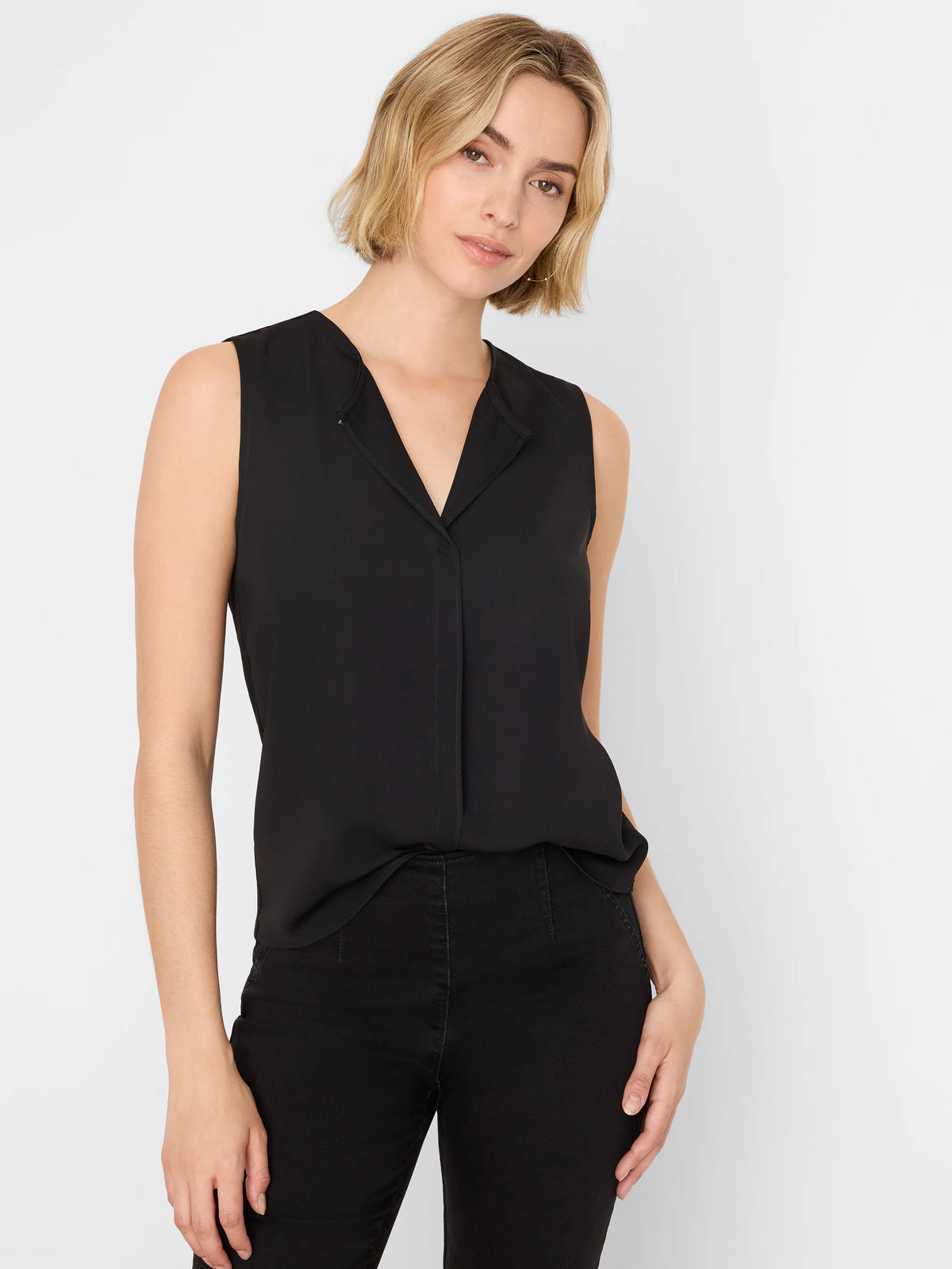 Black sleeveless V-neck top with a collar and hidden button placket. It has a loose, drapey fit.