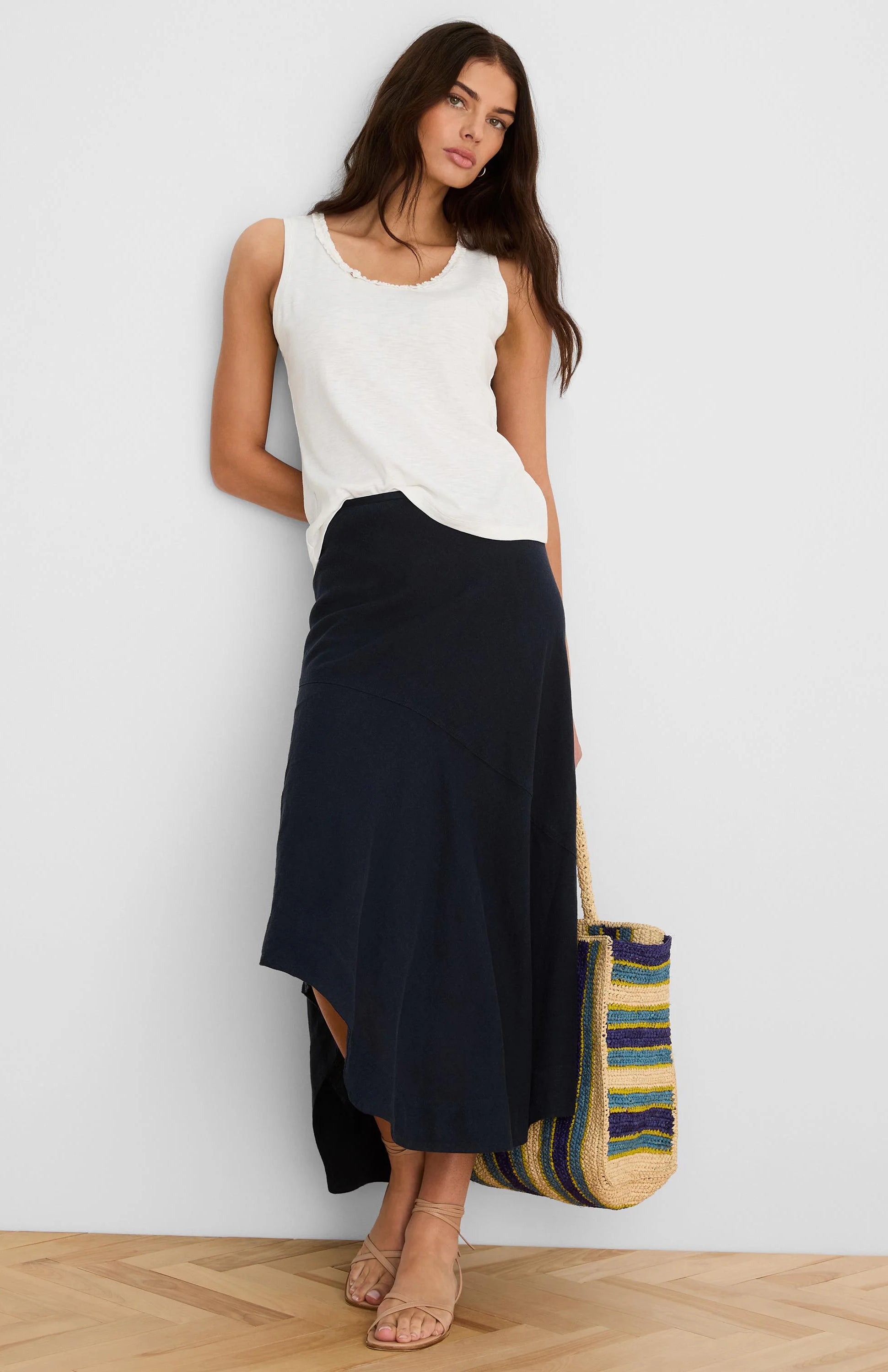 Long navy linen skirt with a relaxed fit and an asymmetric, flowing hem.