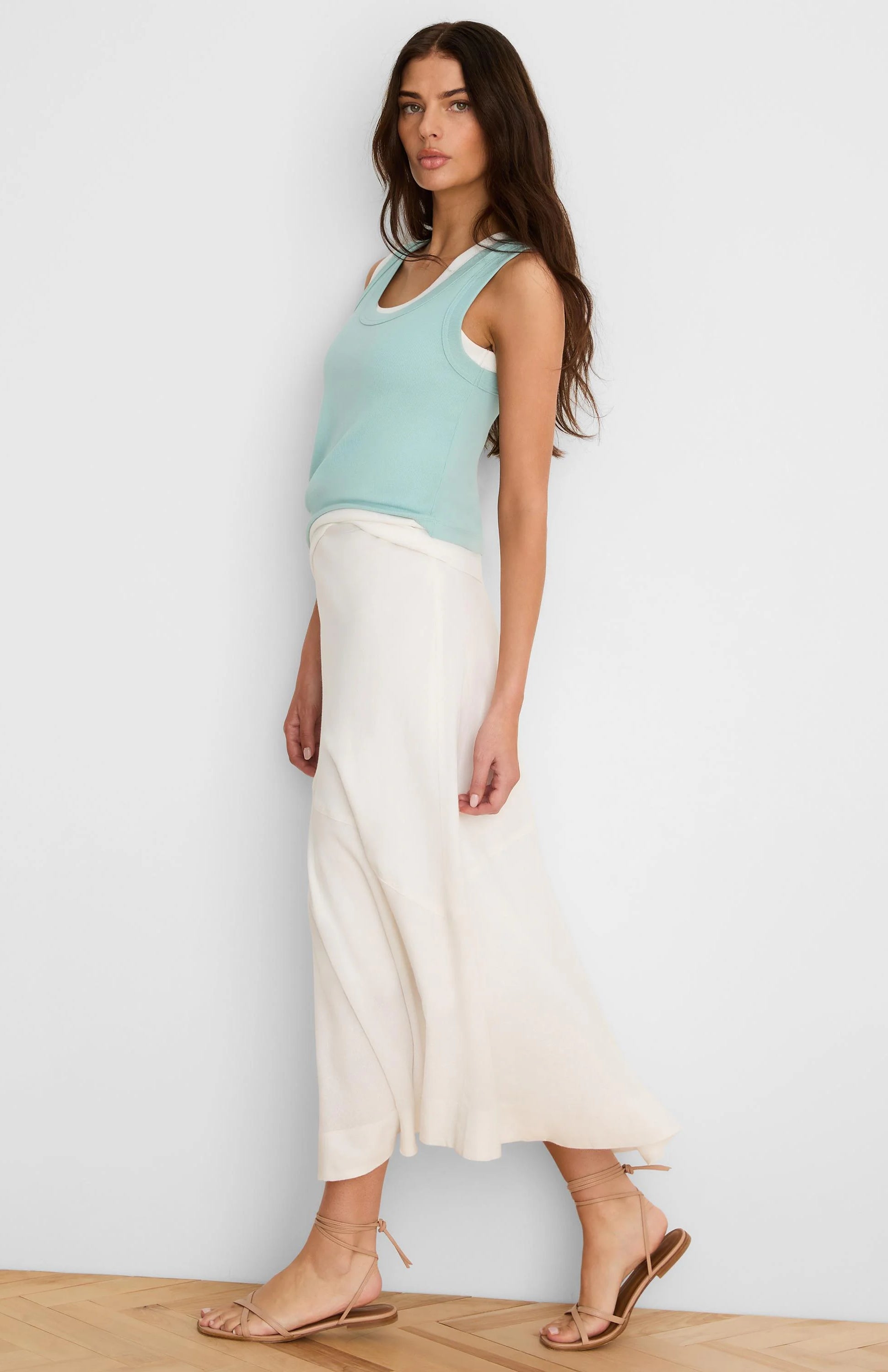 Cream, ankle-length linen skirt with a flowing silhouette, worn by a model.