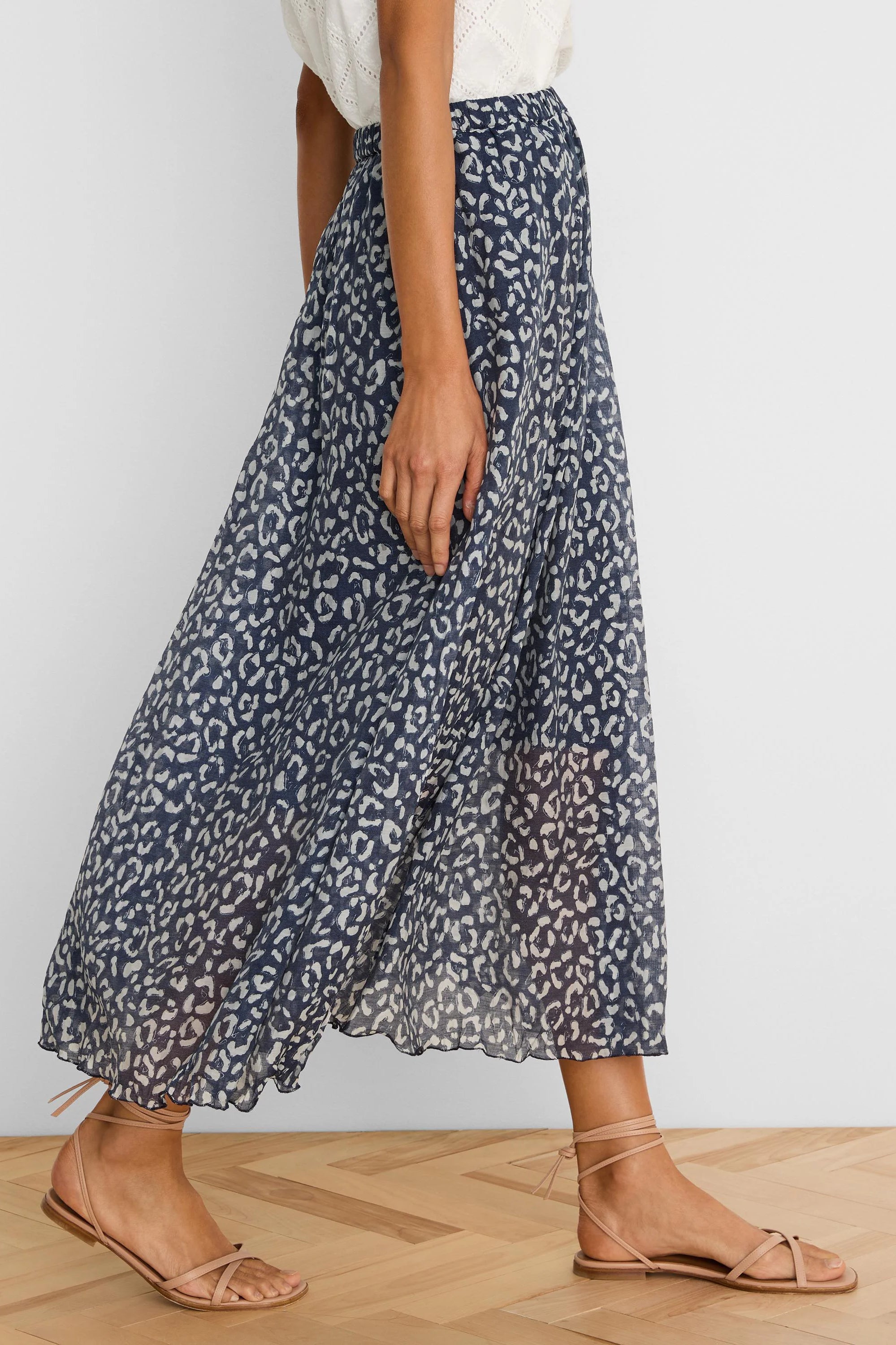 Navy crinkle skirt with a flowy silhouette, featuring a light grey sketchy leopard print and an elasticated waist.