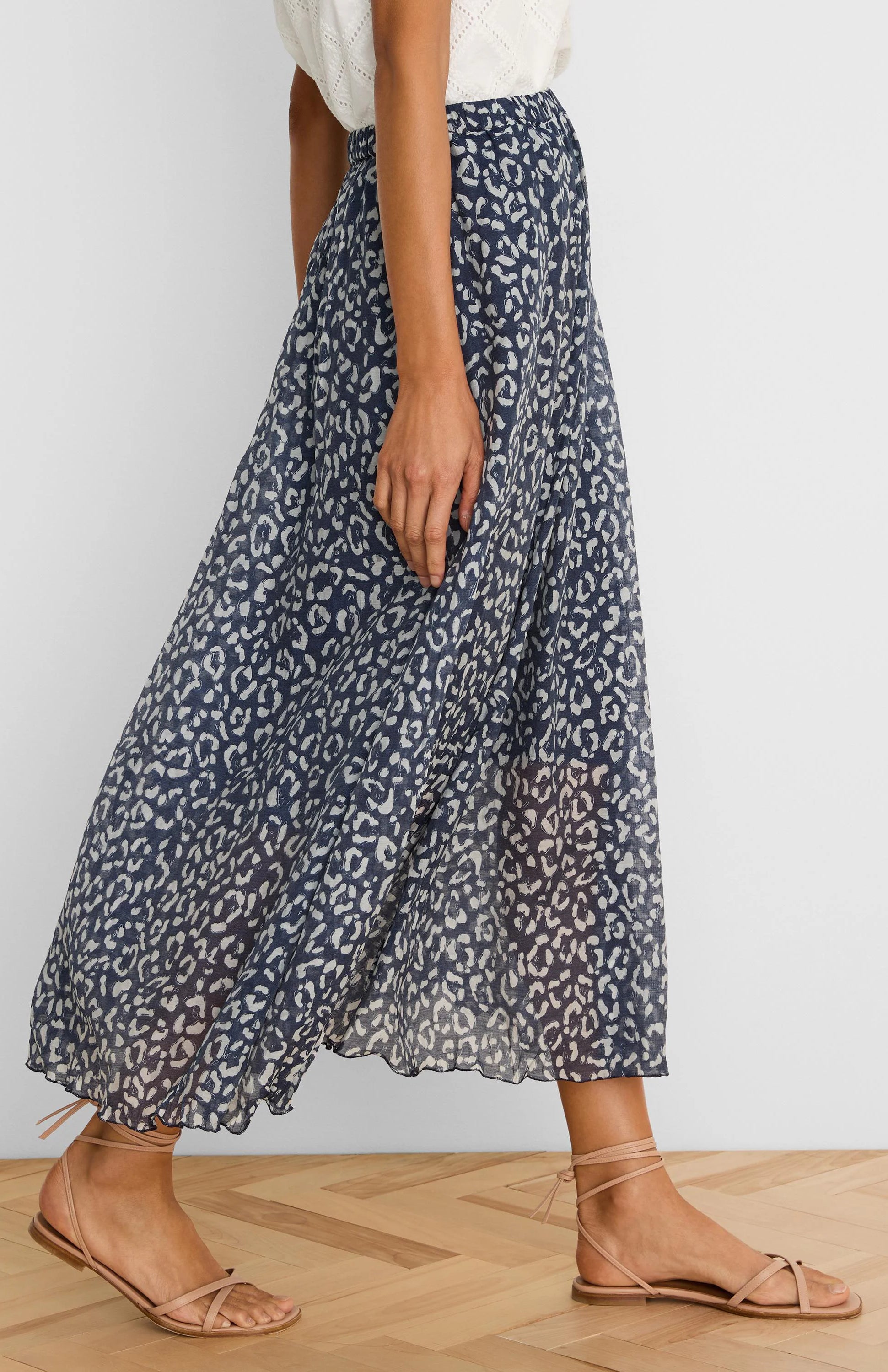 Navy crinkle skirt with a flowy silhouette, featuring a light grey sketchy leopard print and an elasticated waist.