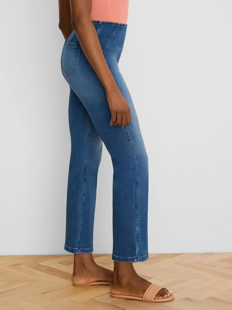 Medium blue bootcut jeans, high-waisted with distinct curved front seams.
