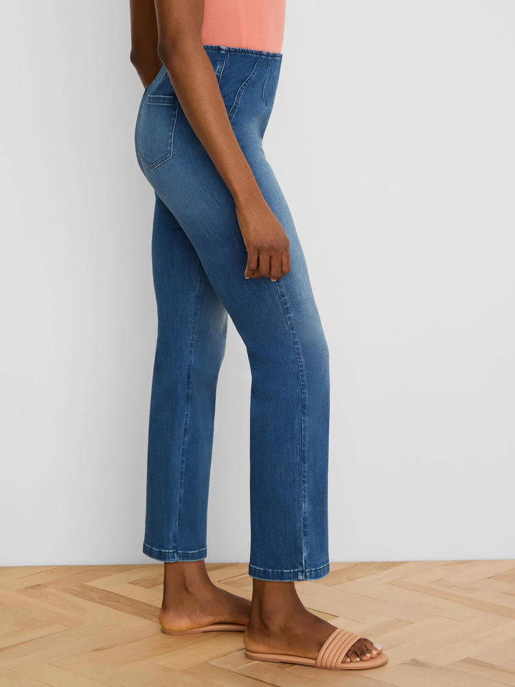 Medium blue ankle bootcut jeans, high-waisted with a structured waistband and diagonal seams.