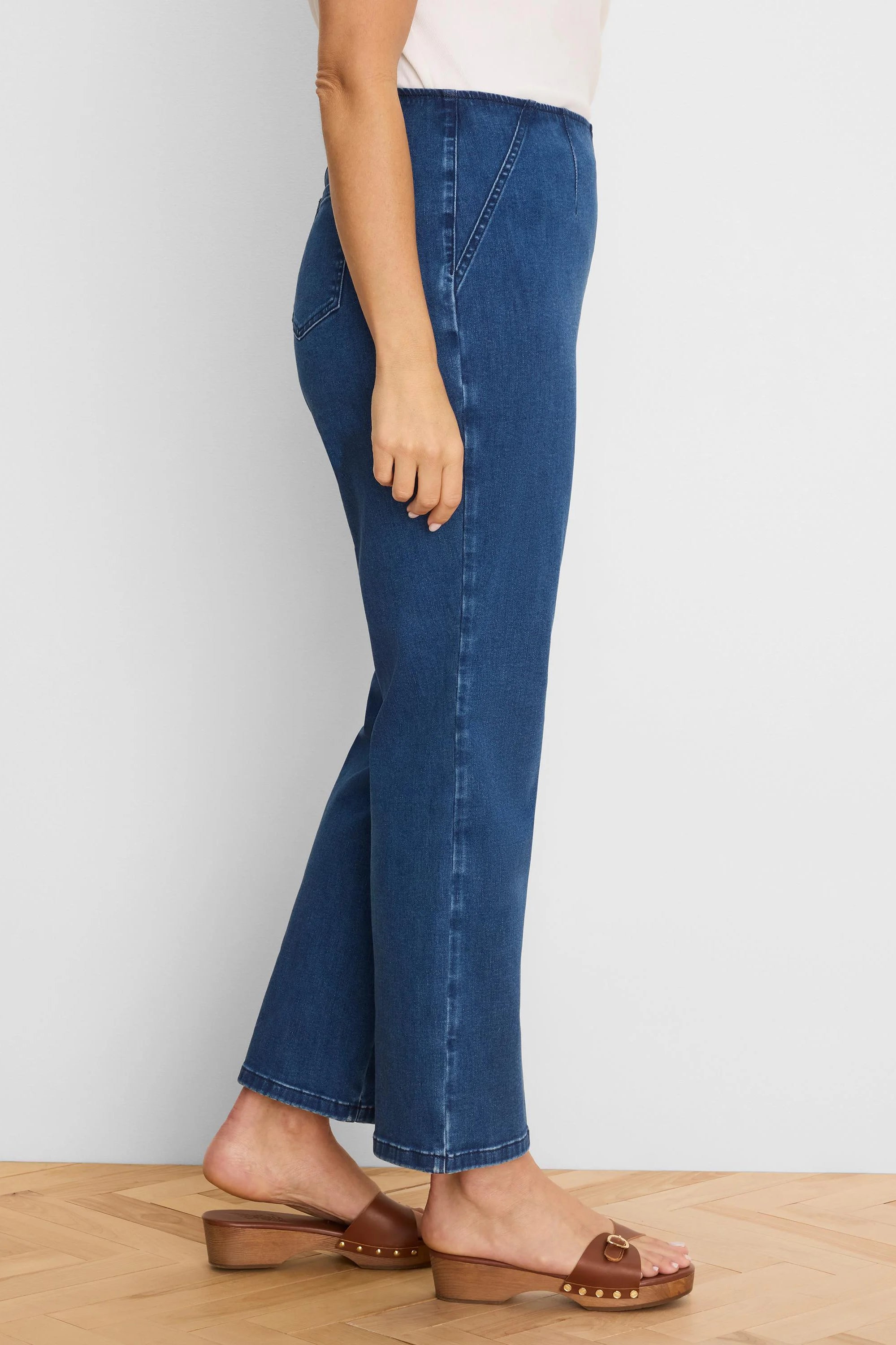 Deep blue high-waisted bootcut jeans. Features a smooth waistband and full-length leg.