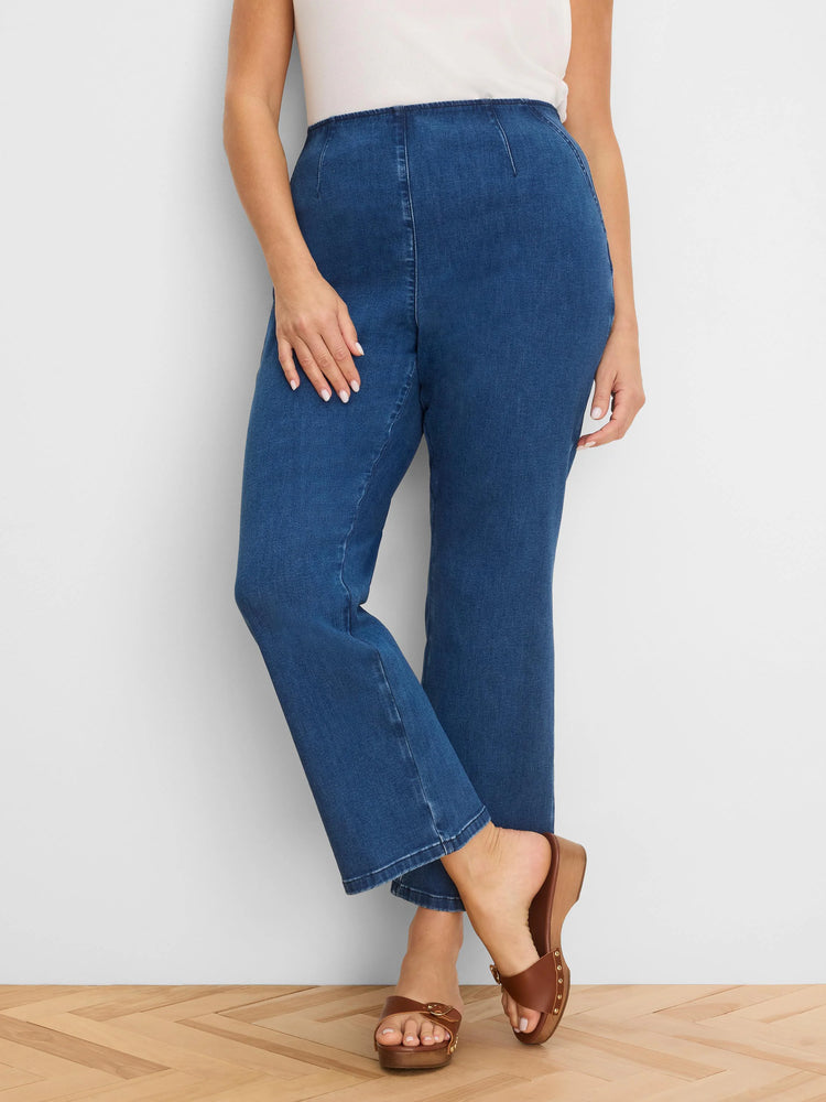 Medium blue high-waist bootcut jeans with visible front and back seams, ending above the ankle.