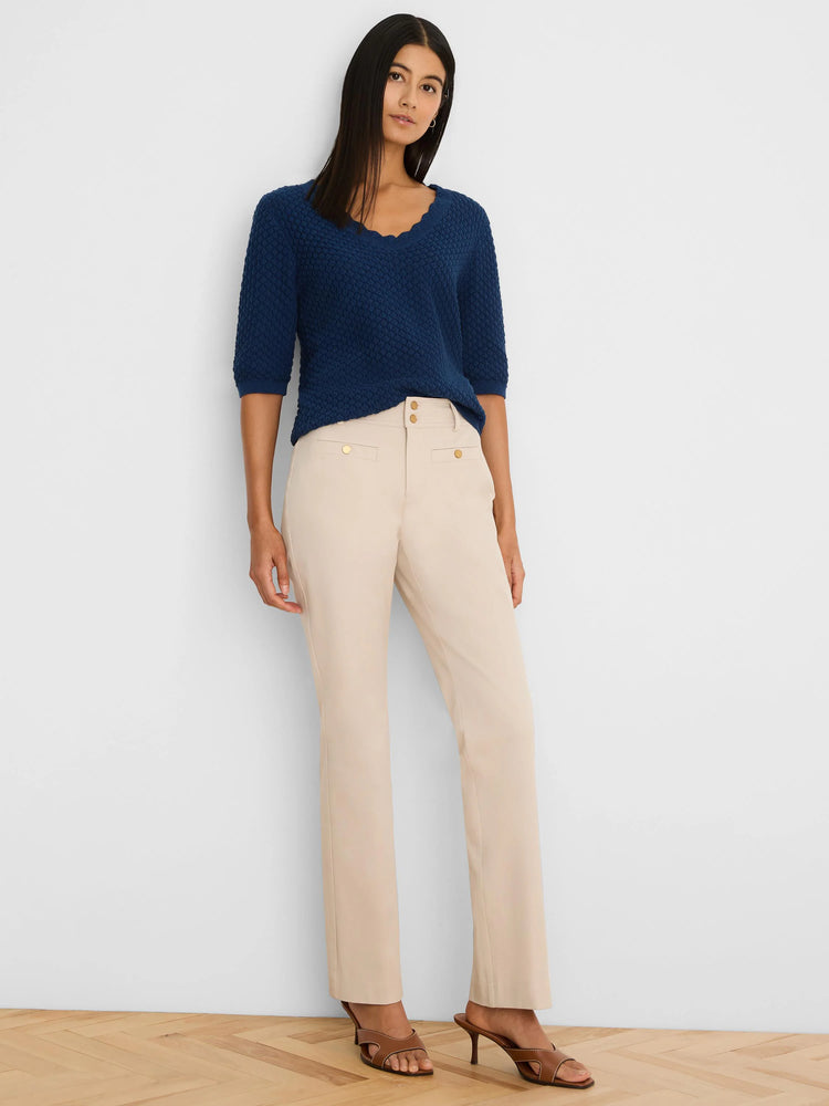 Light beige demi-boot pants with gold button details.