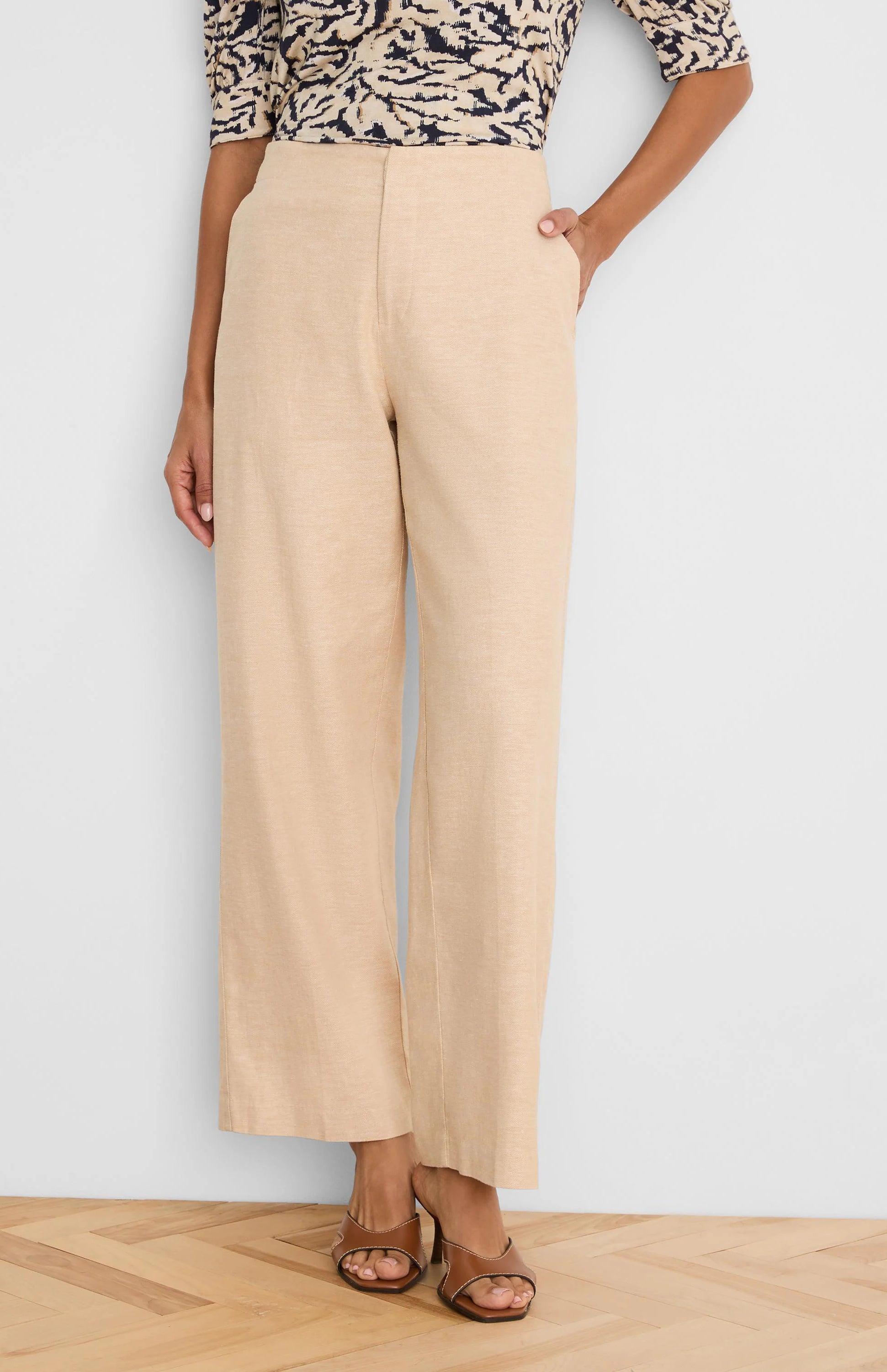 Light beige wide-leg linen pants with a visible front seam and side pockets.