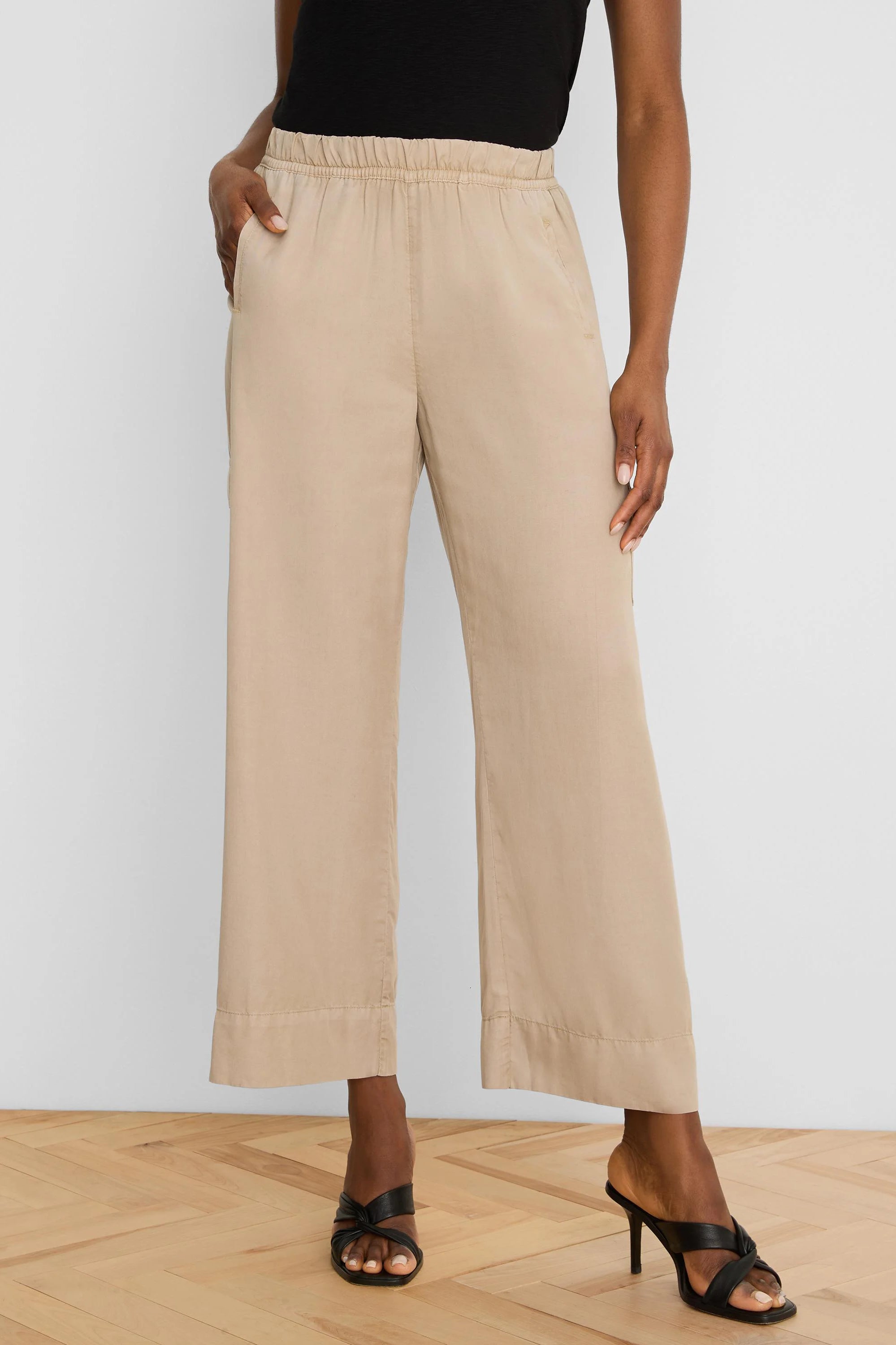 Light tan wide-leg drapey ankle pants with an elastic waist and side pockets.