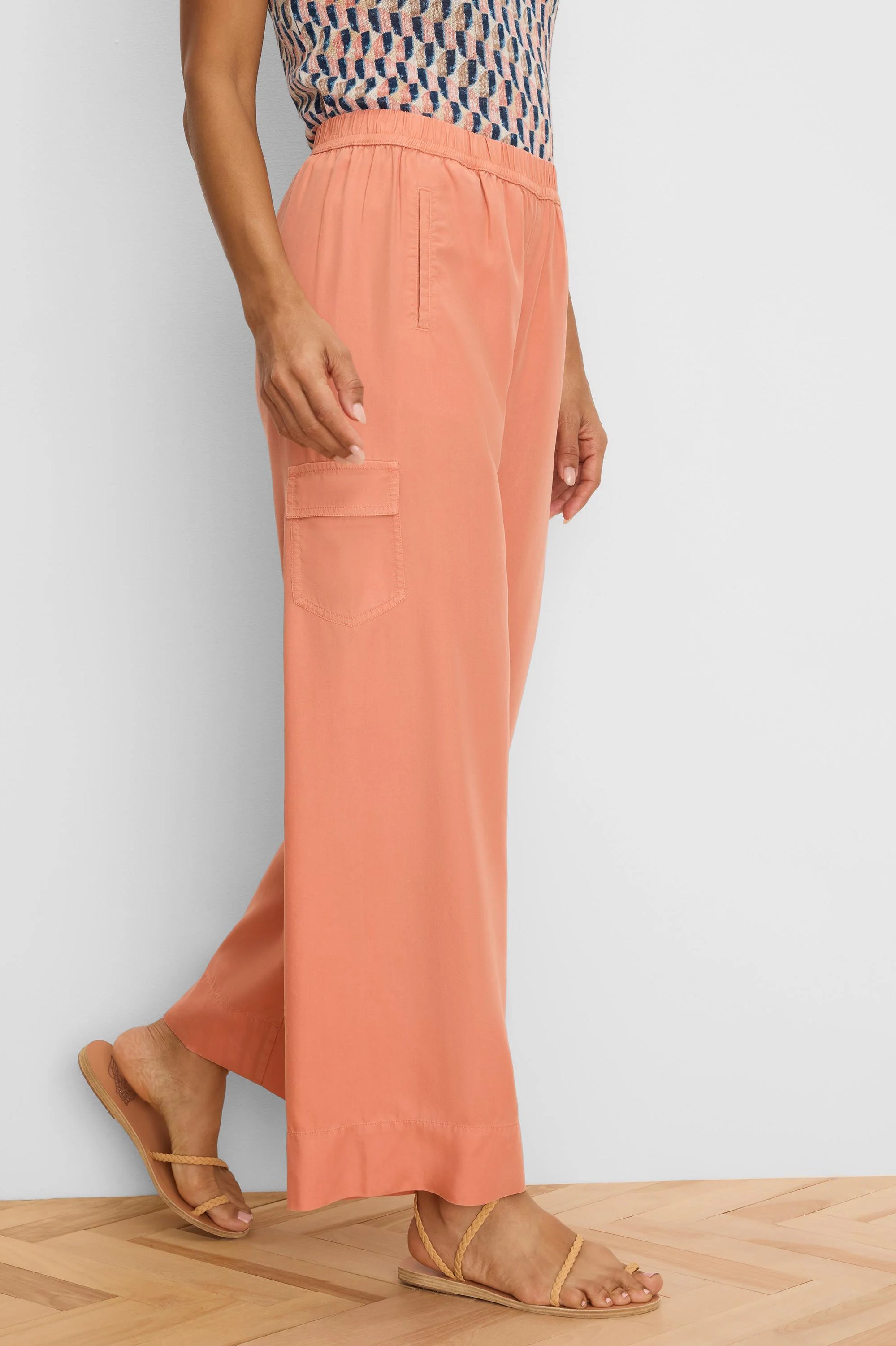 Coral wide-leg drapey cargo ankle pants with an elastic waist and a side flap pocket.