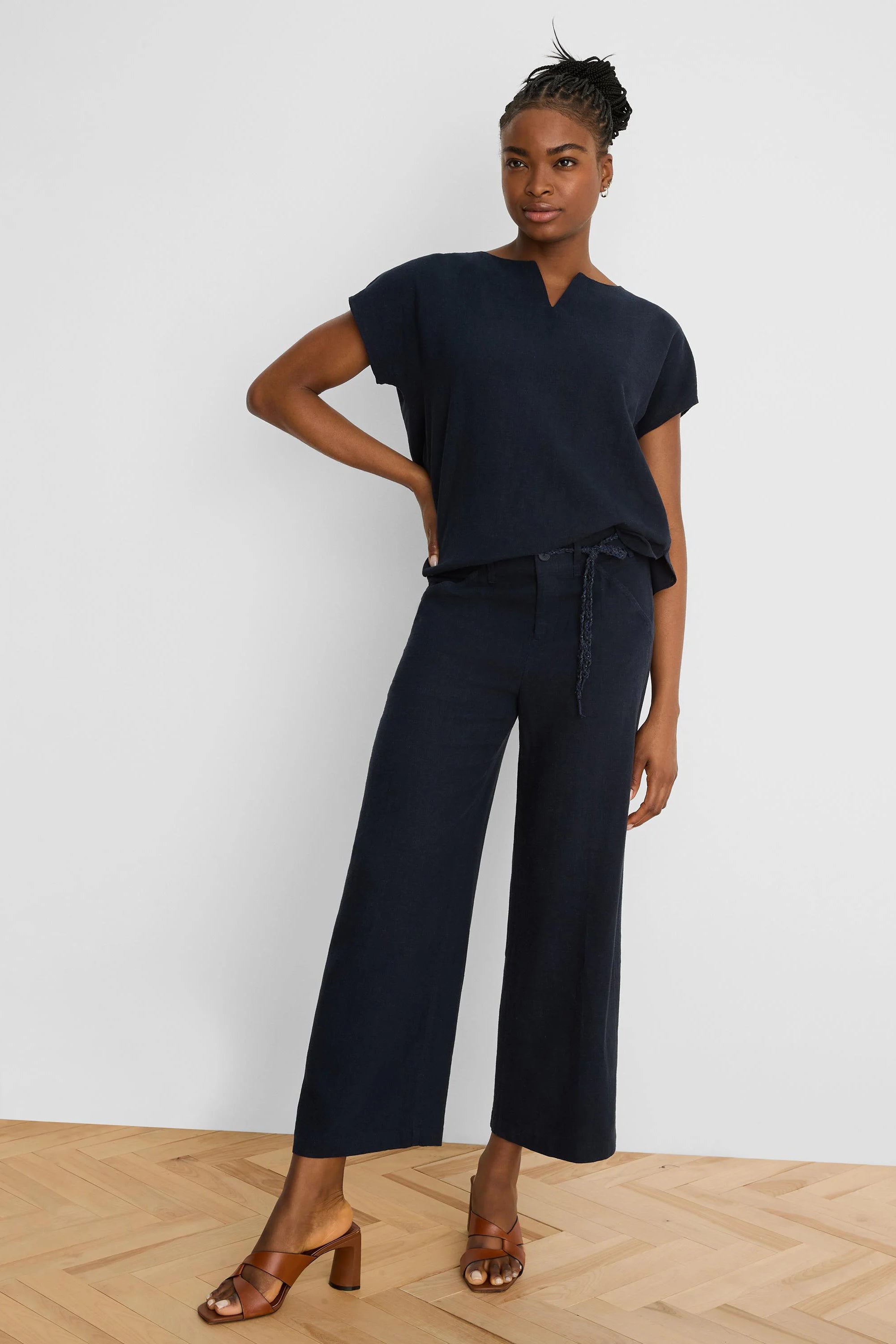 Dark navy wide-leg linen crop pants with a braided self-tie belt.