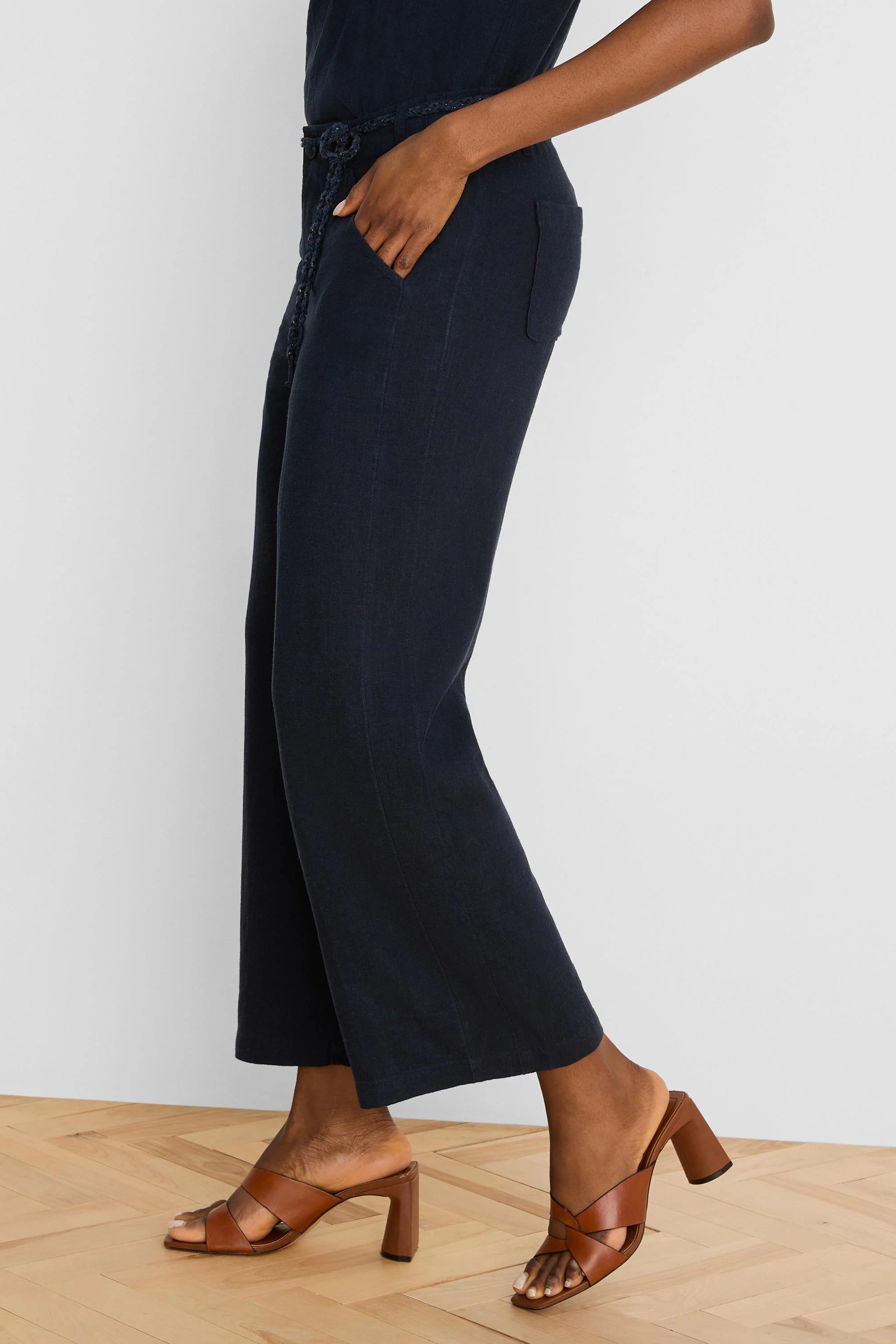 Dark navy wide-leg linen crop pants with braided belt, side and back pockets.