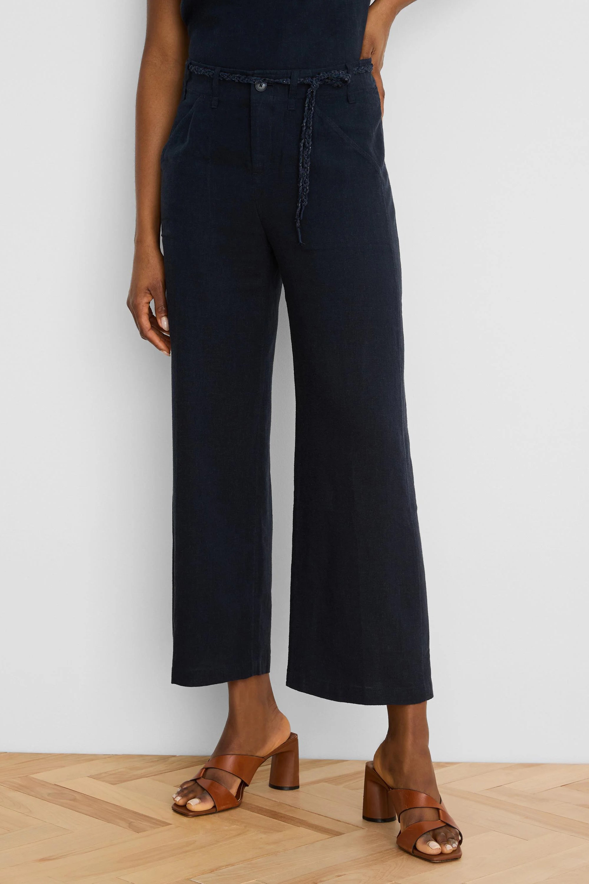 Navy wide-leg cropped linen pants with a braided self-fabric belt.