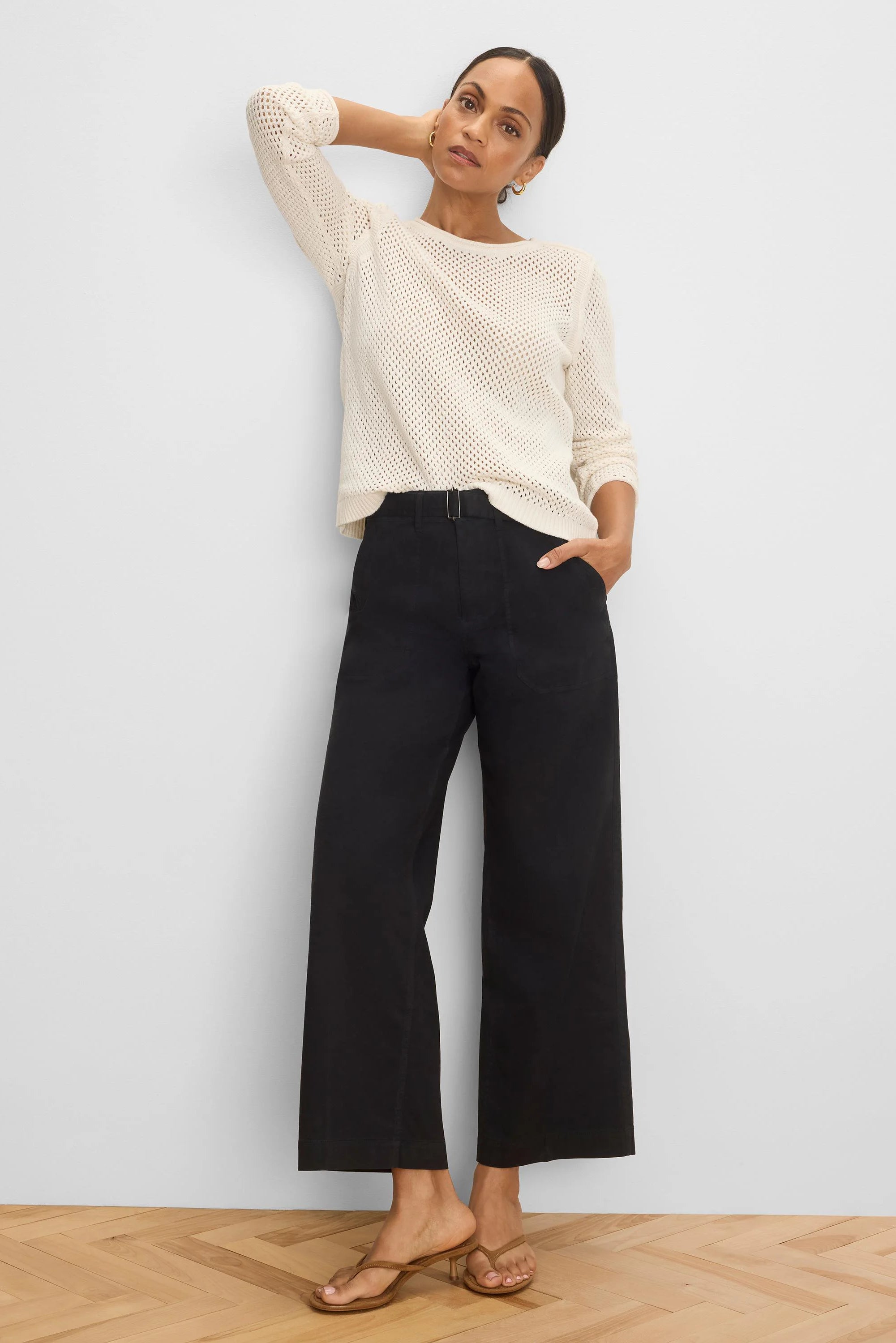 Black wide-leg belted ankle pants with a rectangular metal buckle.