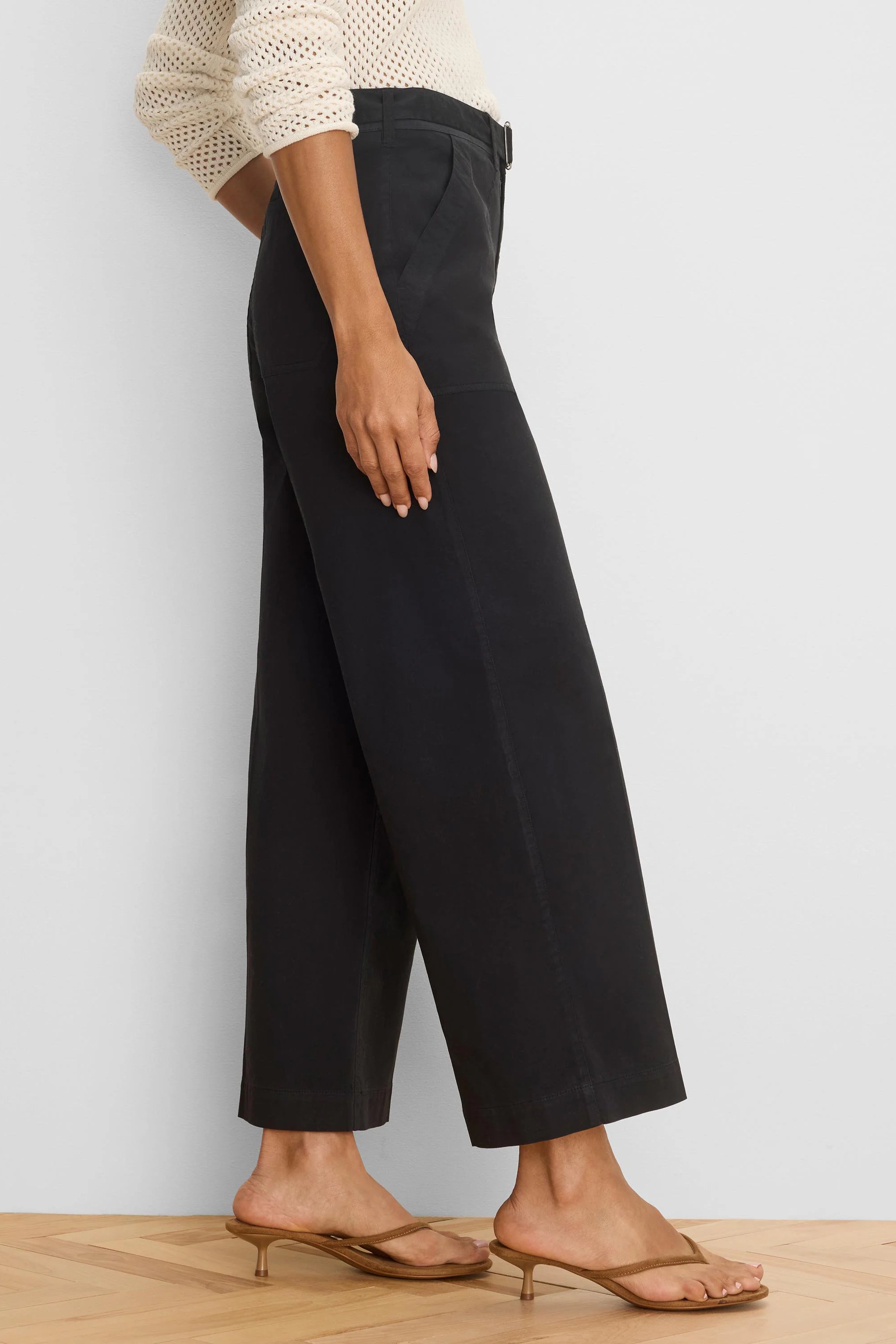 Black wide-leg ankle pants with a belted waist, soft drape, and side pockets.