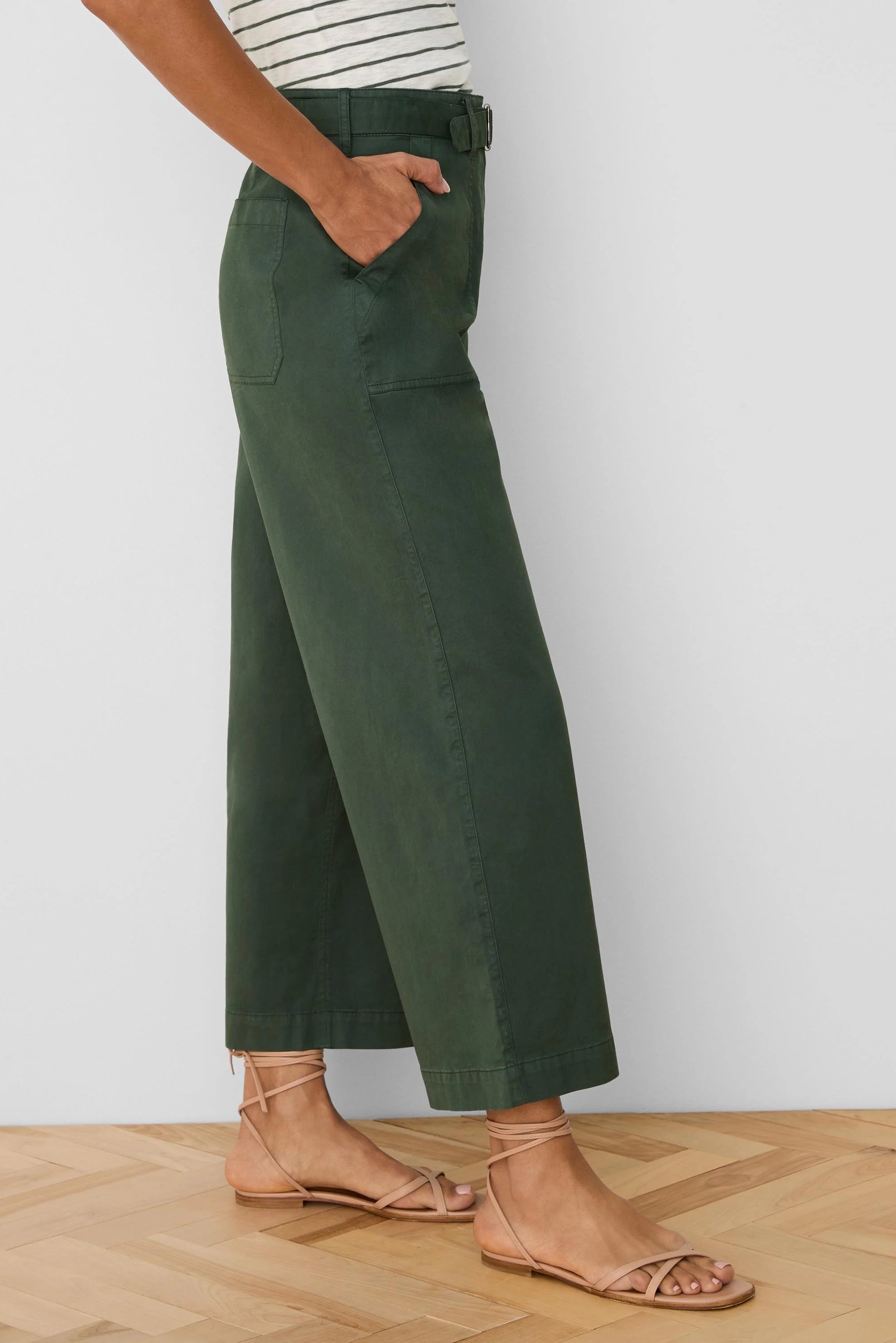 Dark green wide-leg ankle pants with a belted waist and side pockets.