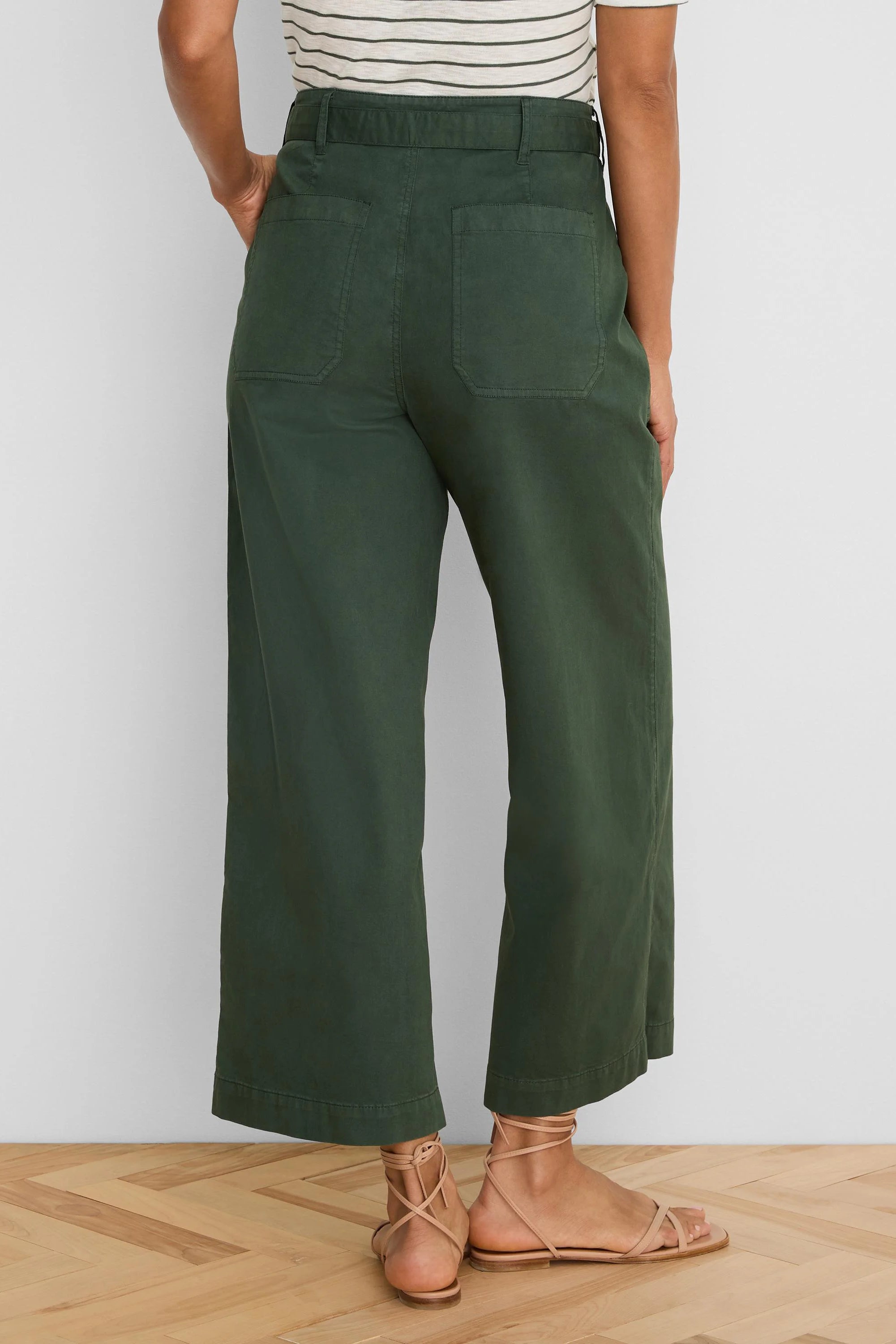Dark green wide-leg ankle pants. Back view shows patch pockets and belt loops.