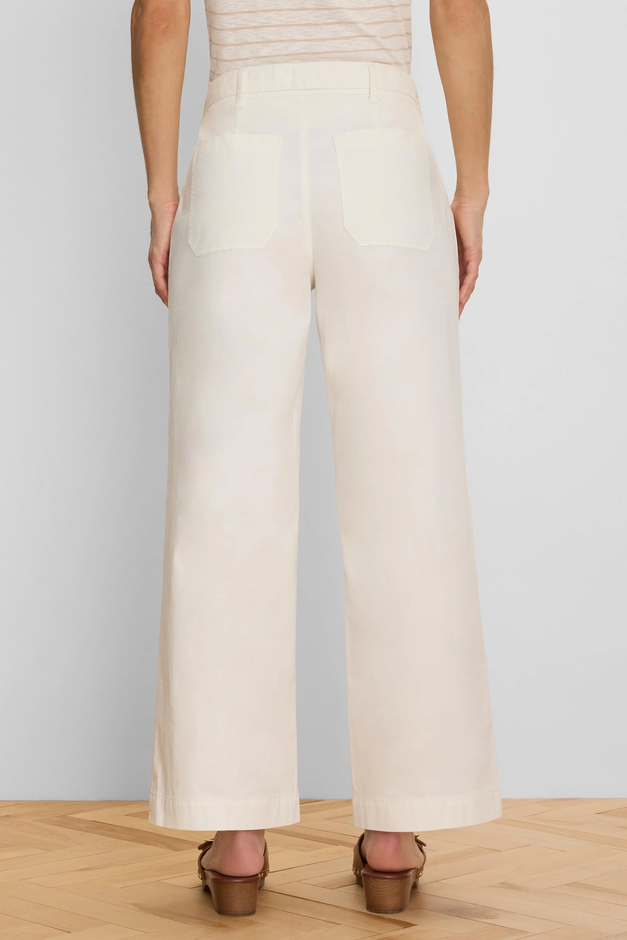 Cream wide-leg ankle pants, back view. Features belt loops and two back patch pockets.