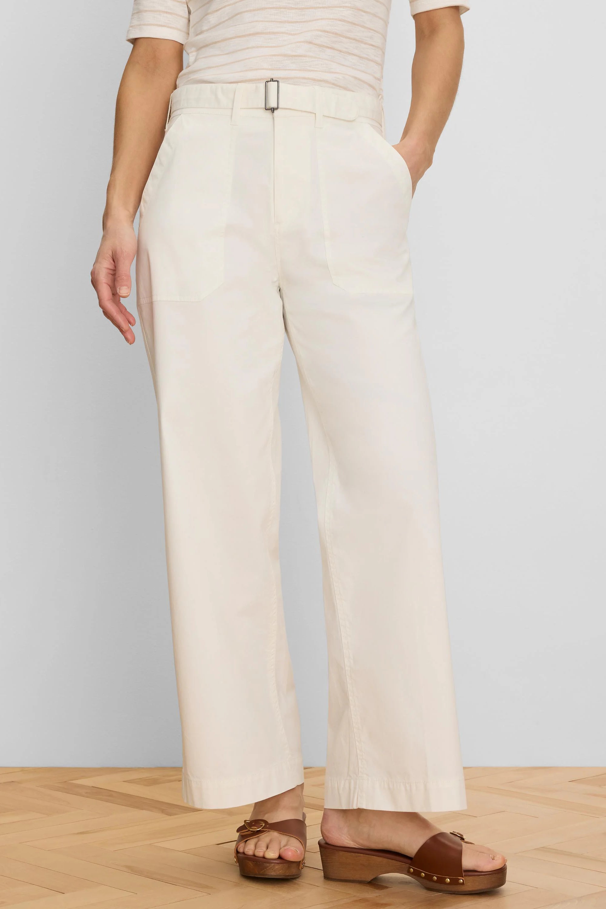 Cream wide-leg ankle pants with a fabric belt, black rectangular buckle, and front patch pockets.