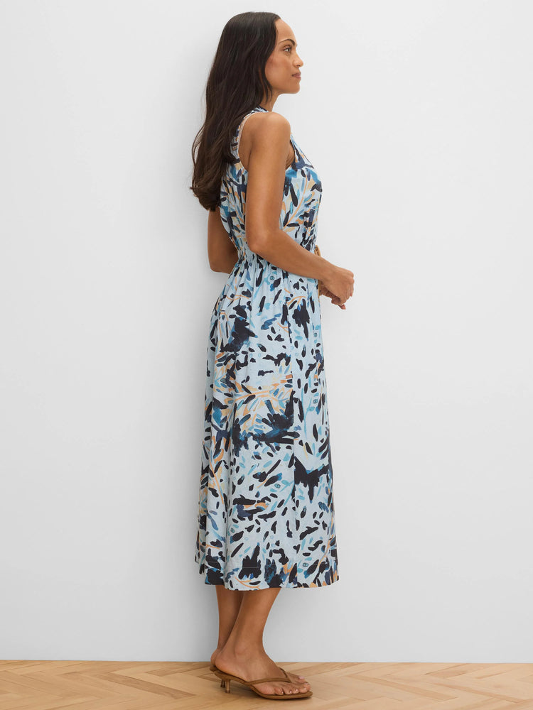 Sleeveless light blue midi dress with abstract dark blue, black, and orange brushstroke pattern. Cinched waist.