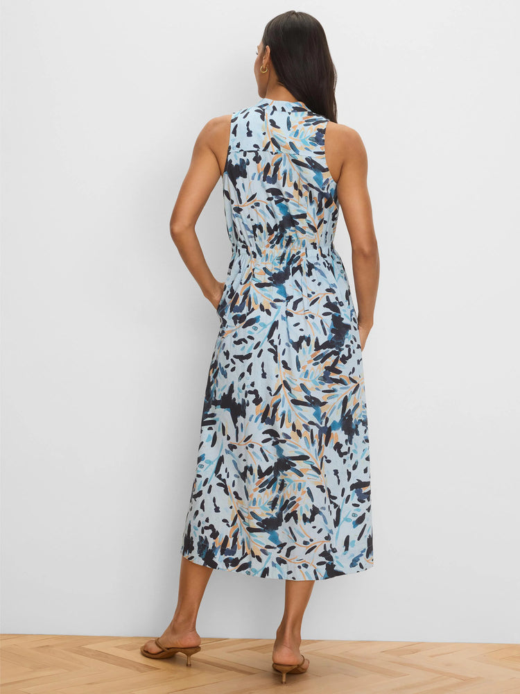 Light blue sleeveless midi dress with abstract dark blue, medium blue, and sienna patterns, cinched waist, and pockets.