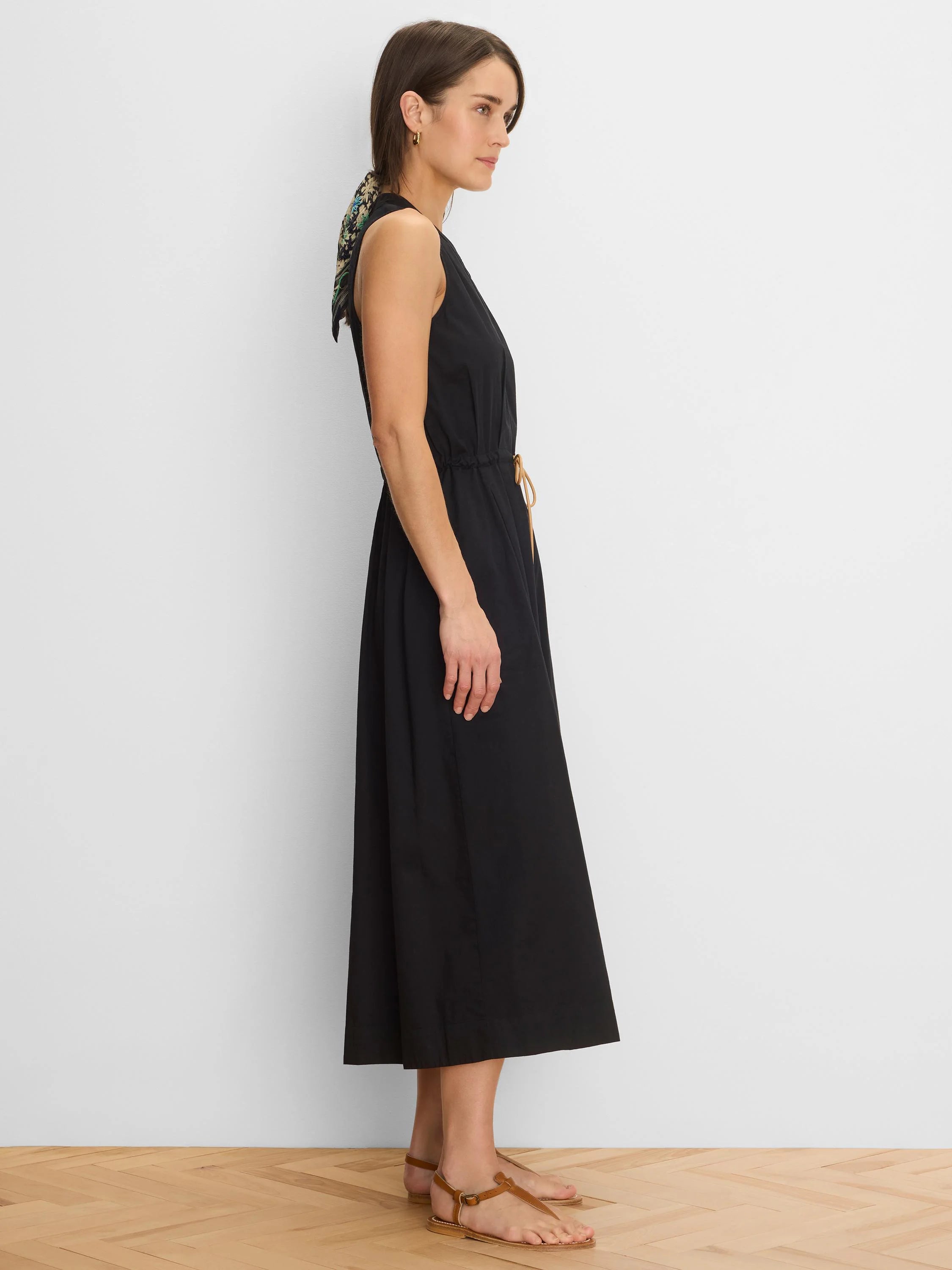 Black sleeveless Sienna Dress with a gathered V-neck, tan drawstring waist, and midi length.
