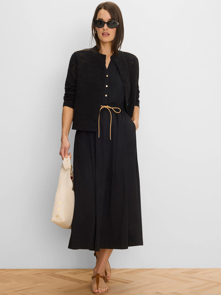 Black midi-length dress with a V-neck, golden front buttons, and a tan drawstring waist.