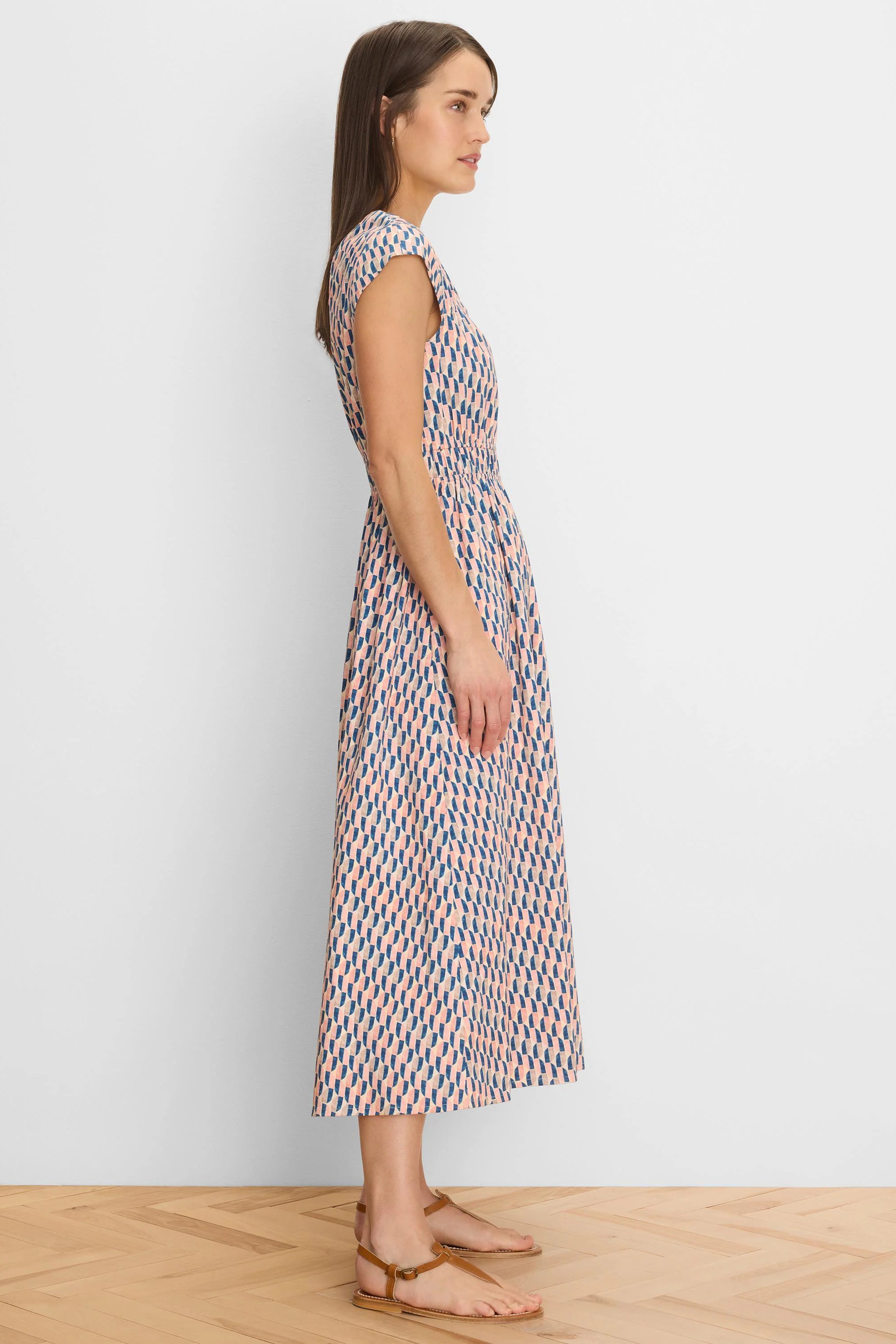 Cap sleeve midi dress with a gathered waist, featuring a geometric pattern in muted blue, peach, and tan.