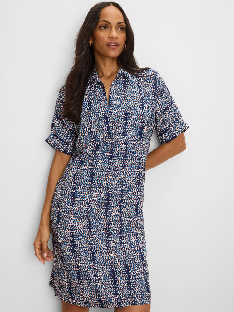 Navy blue shift dress with short cuffed sleeves, collared V-neck, and a scattered square print in light blue, peach, and...