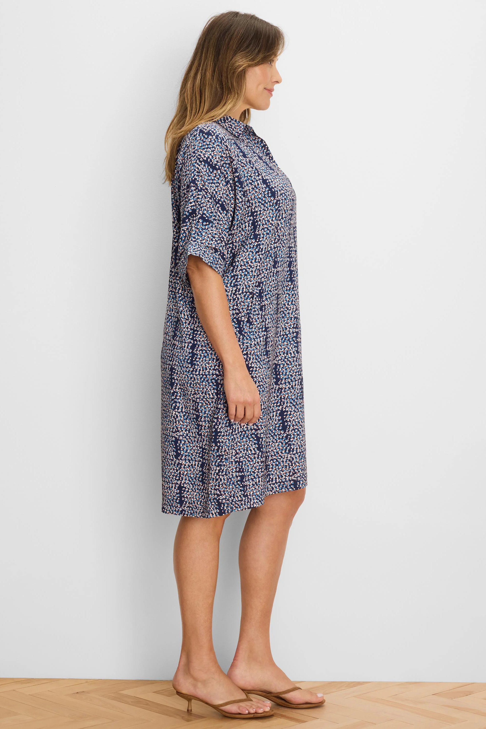 Navy collared dress with abstract light blue, white, and peach block pattern. Relaxed fit, elbow sleeves, above knee.