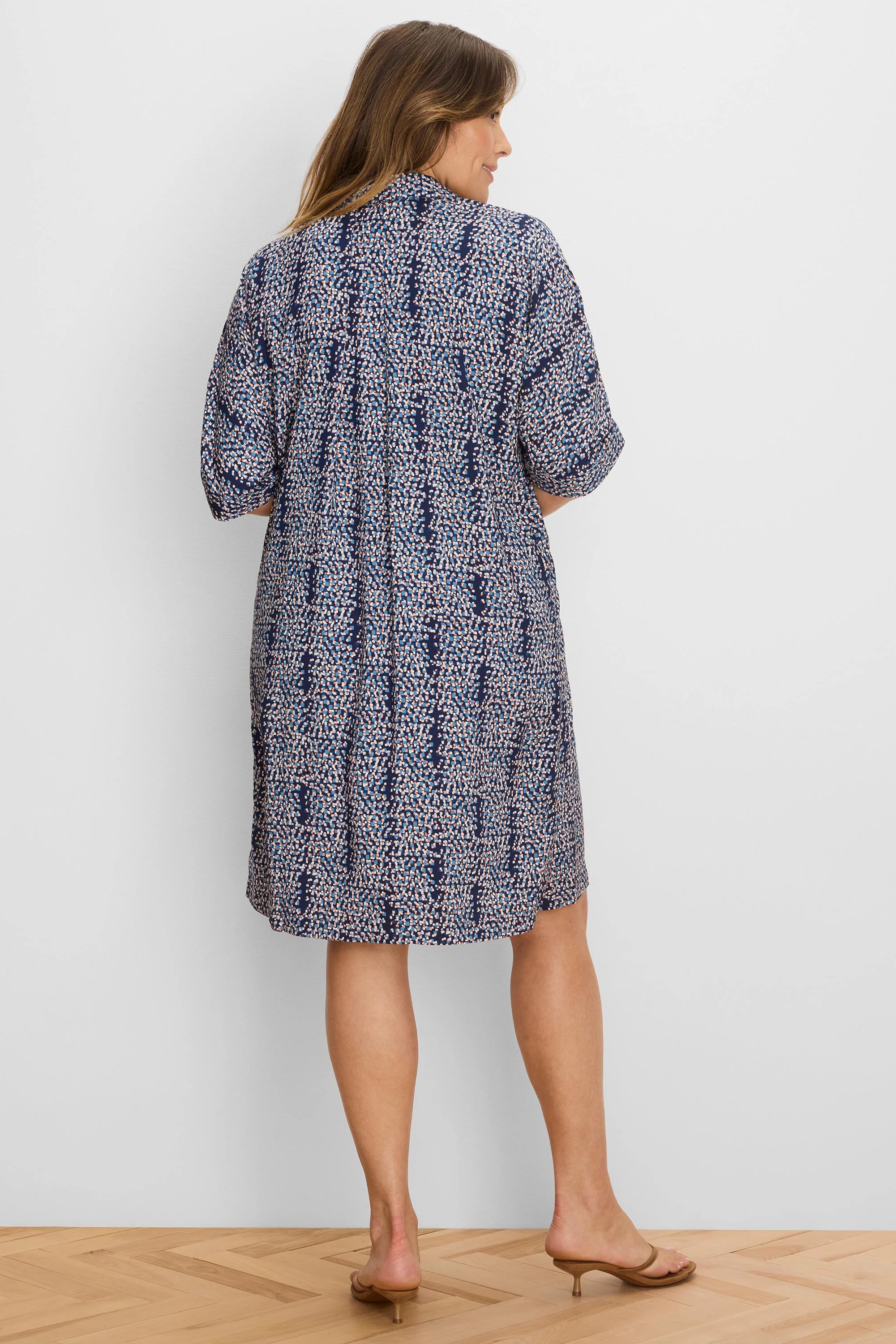 Navy dress with scattered light blue and peach block pattern. Knee-length, short sleeves, relaxed fit.
