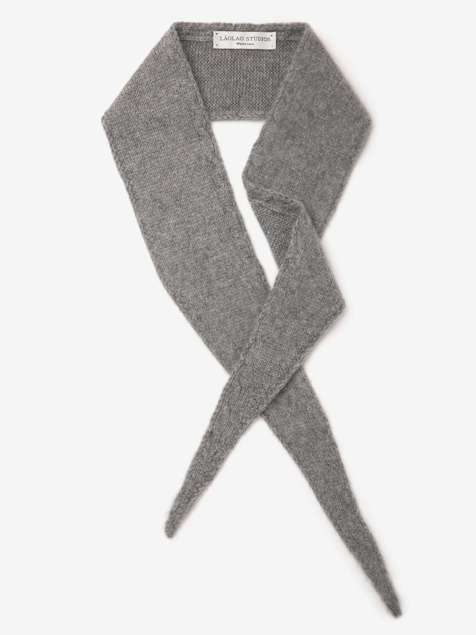 Grey knitted mini scarf with a fuzzy texture, laid flat showing crossed, tapered ends.