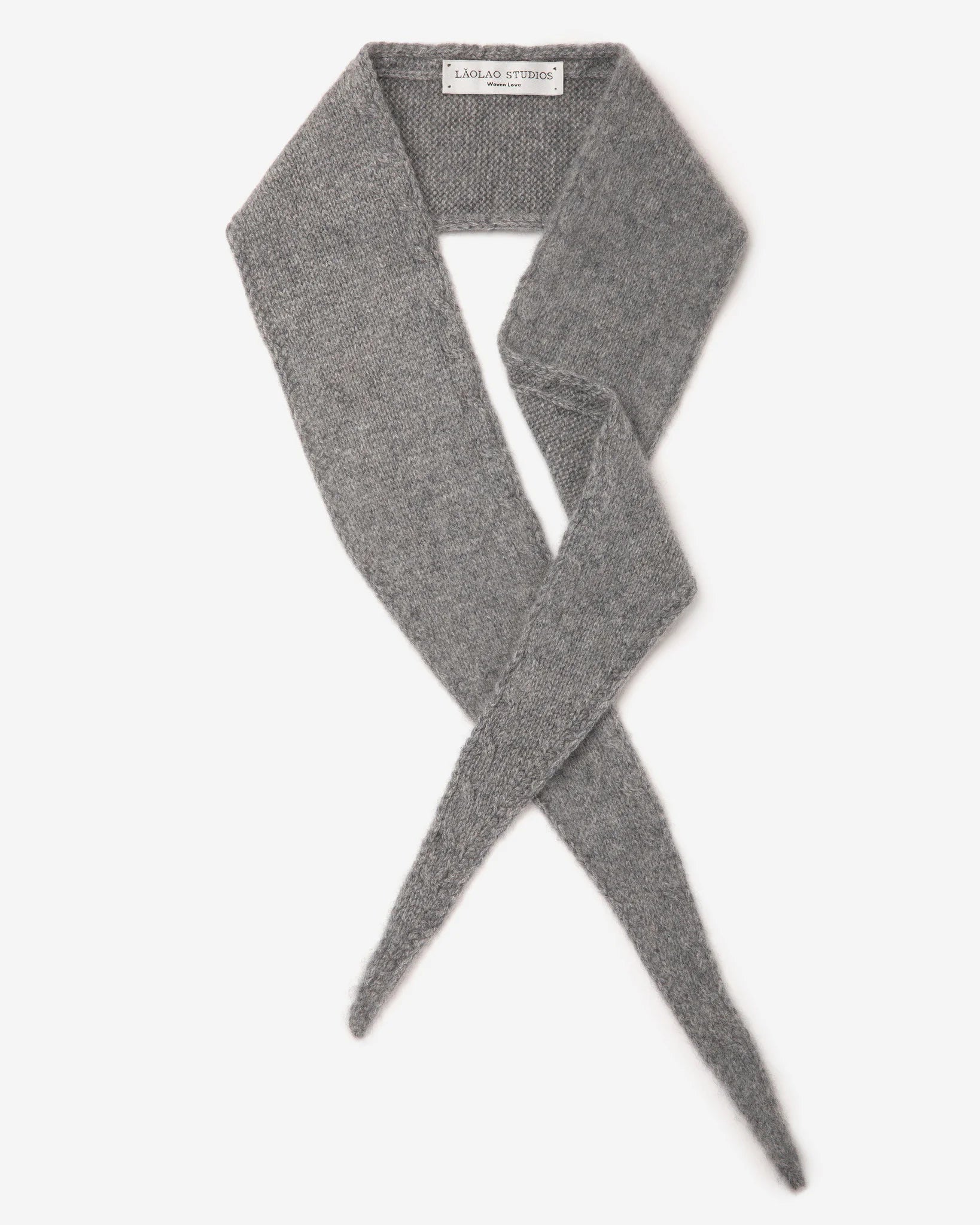 Grey knitted mini scarf with a fuzzy texture, laid flat showing crossed, tapered ends.