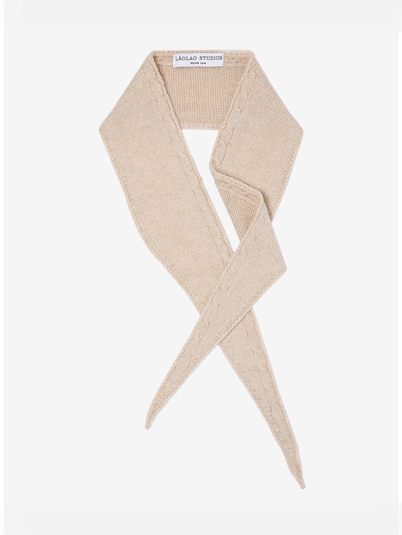 Beige cable knit mini scarf, styled with crossed, tapering ends.