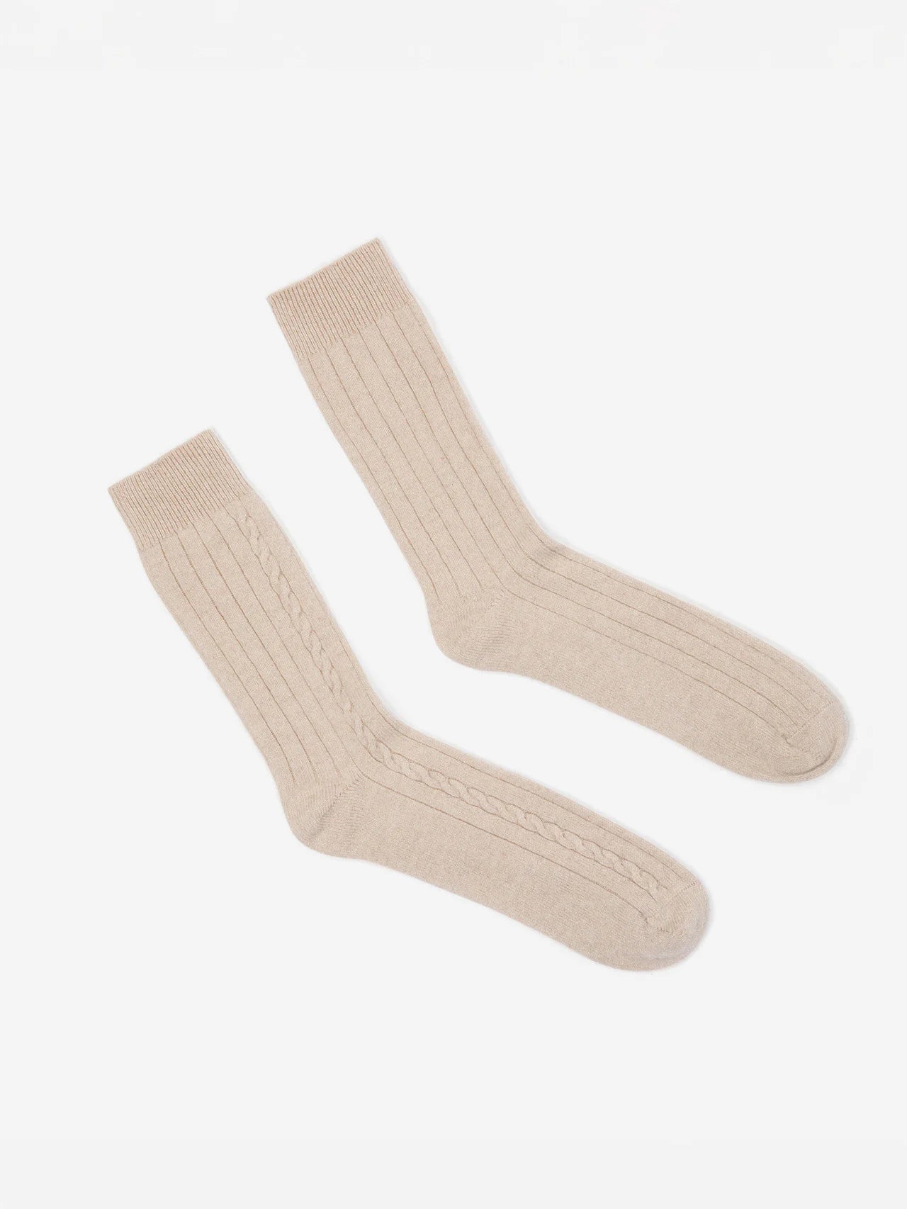 Light beige ribbed socks with a central cable knit pattern.