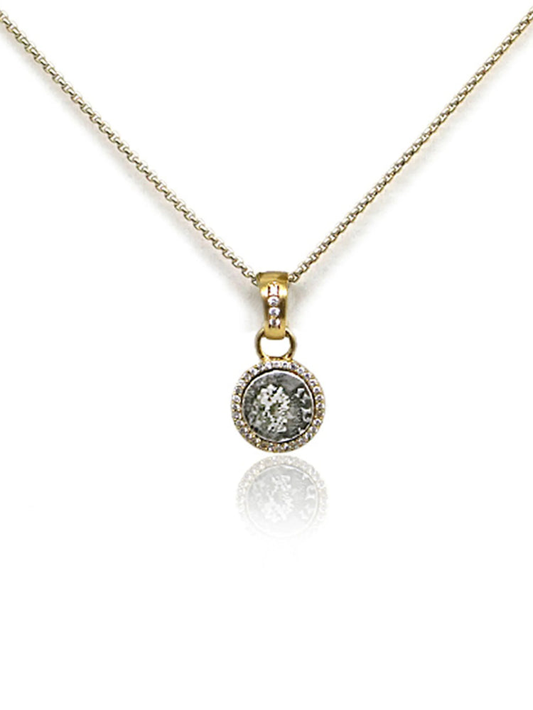 Gold chain and circular pendant. Pendant features a gray coin-like center, framed by small clear stones and gold.