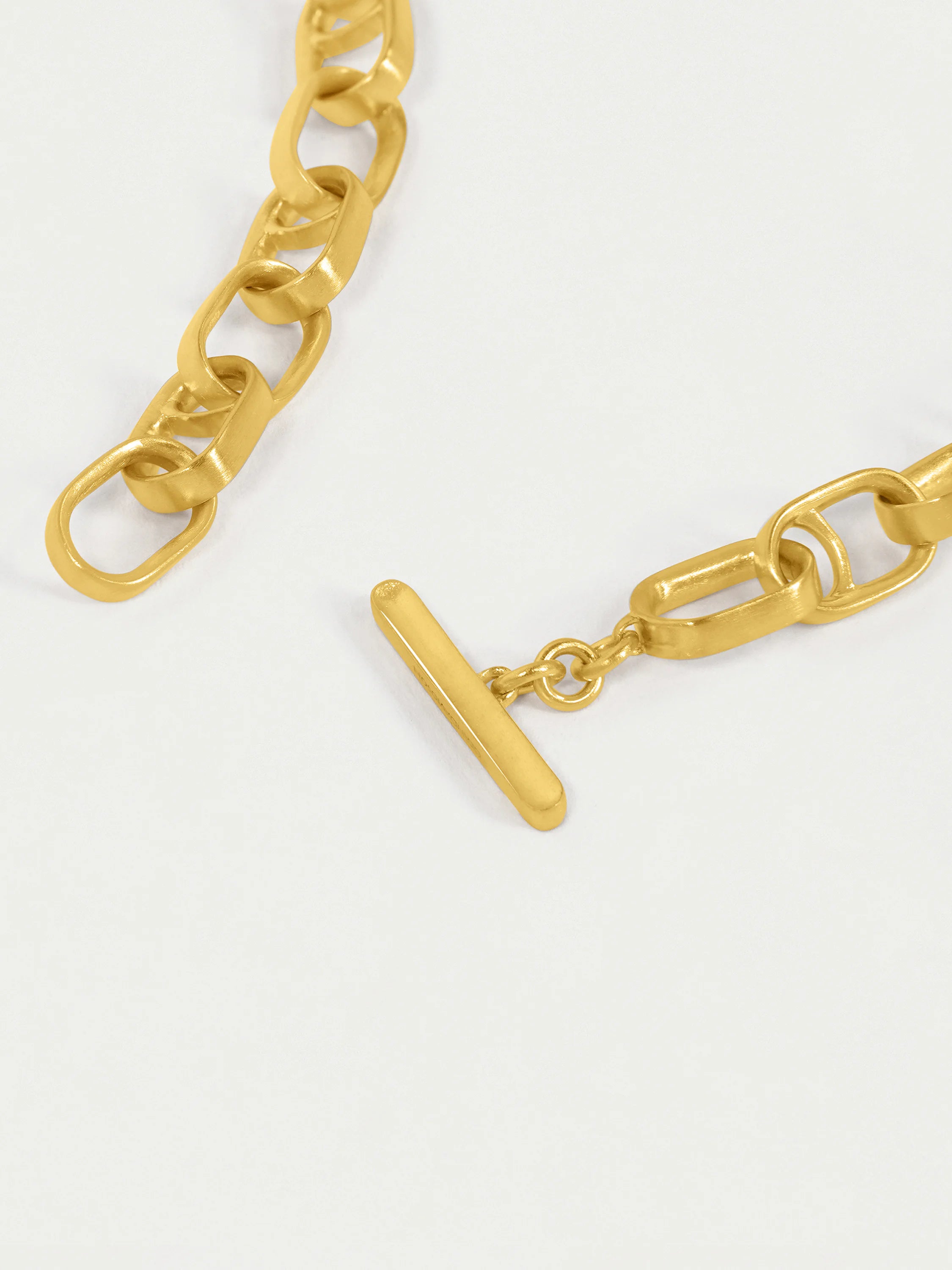 Gold interlocking chain necklace with a T-bar clasp.